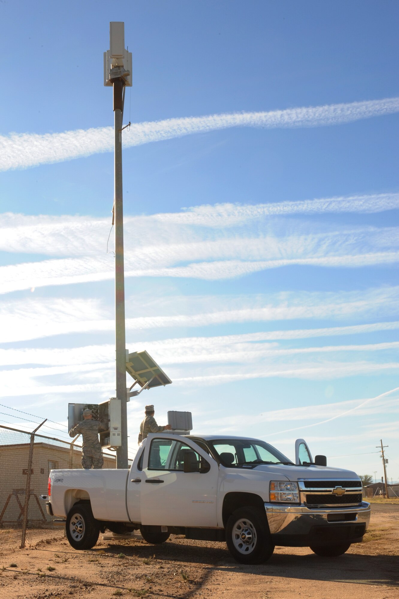 U.S. Air Force Senior Airmen Kevin Davis and Garrett Leeper, 355th Communications Squadron radio frequency transmissions systems technicians, perform a preventive maintenance inspection on a giant voice pole at Davis-Monthan Air Force Base, Ariz., Dec. 22, 2014. The 355th CS mission is to maintain and operate voice and data telecommunications along with computer network, radar and navigational aids. (U.S. Air Force photo by Airman 1st Class Cheyenne Morigeau/Released)
