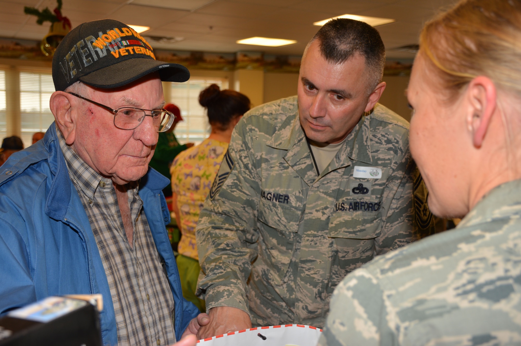 A World War II vet thanks Senior Master Sgt. Gary Wagner, 507th Maintenance Squadron for the Christmas gifts during the Annual Norman Veterans Center Christmas Party Dec. 22.  Wagner and more than 25 other Reserve and Guard Airman spent the day with the vets to listing to stories, making jokes and celebrating the holiday. (U.S. Air Force Photo/Maj. Jon Quinlan) 