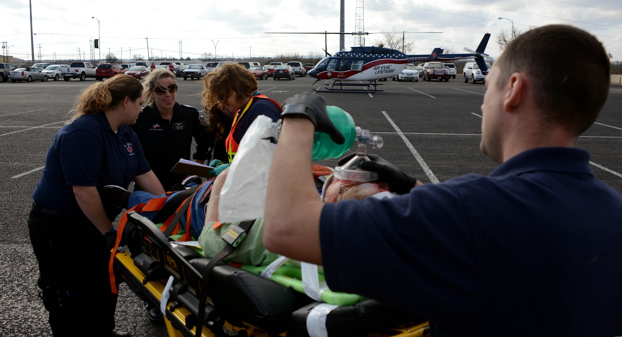 Emergency medical technician students from Texas State Technical College relay a simulated patient’s information to an Air Evac Lifeteam member Dec. 12, 2014, at Abilene, Texas. During the mass casualty exercise, Dyess firefighters and EMT students removed and tended to mock casualties while ambulatory and air evacuation units contributed realistic services to the event. (U.S. Air Force photo by Senior Airman Peter Thompson/Released)
