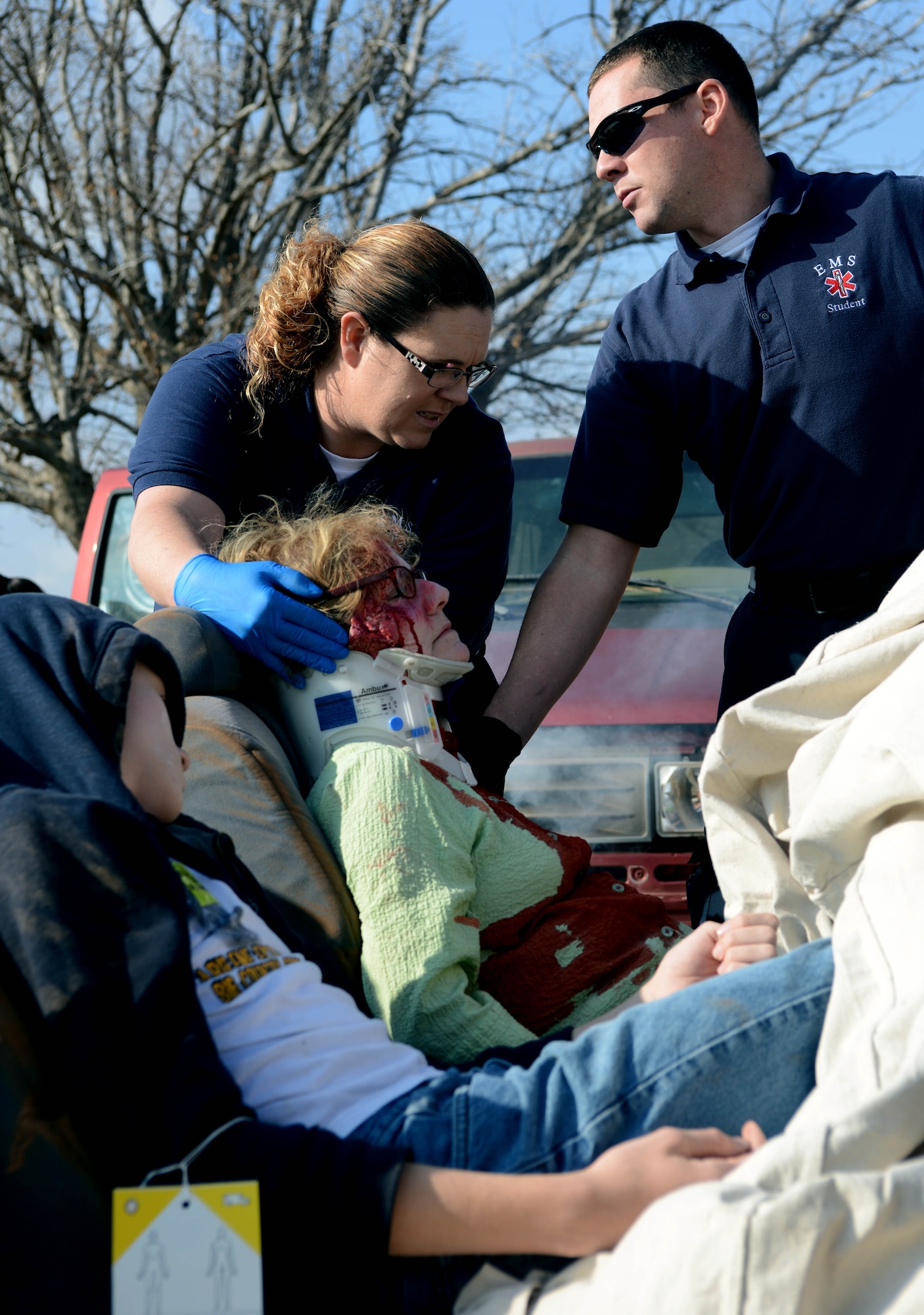 Students attending the Texas State Technical College emergency medical technician course practice stabilizing a victim’s neck Dec. 12, 2014, at Texas State Technical College in Abilene, Texas. The students worked with firefighters from Dyess Air Force Base to remove simulated, injured patients from vehicles during a mass casualty exercise. (U.S. Air Force photo by Senior Airman Peter Thompson/Released)