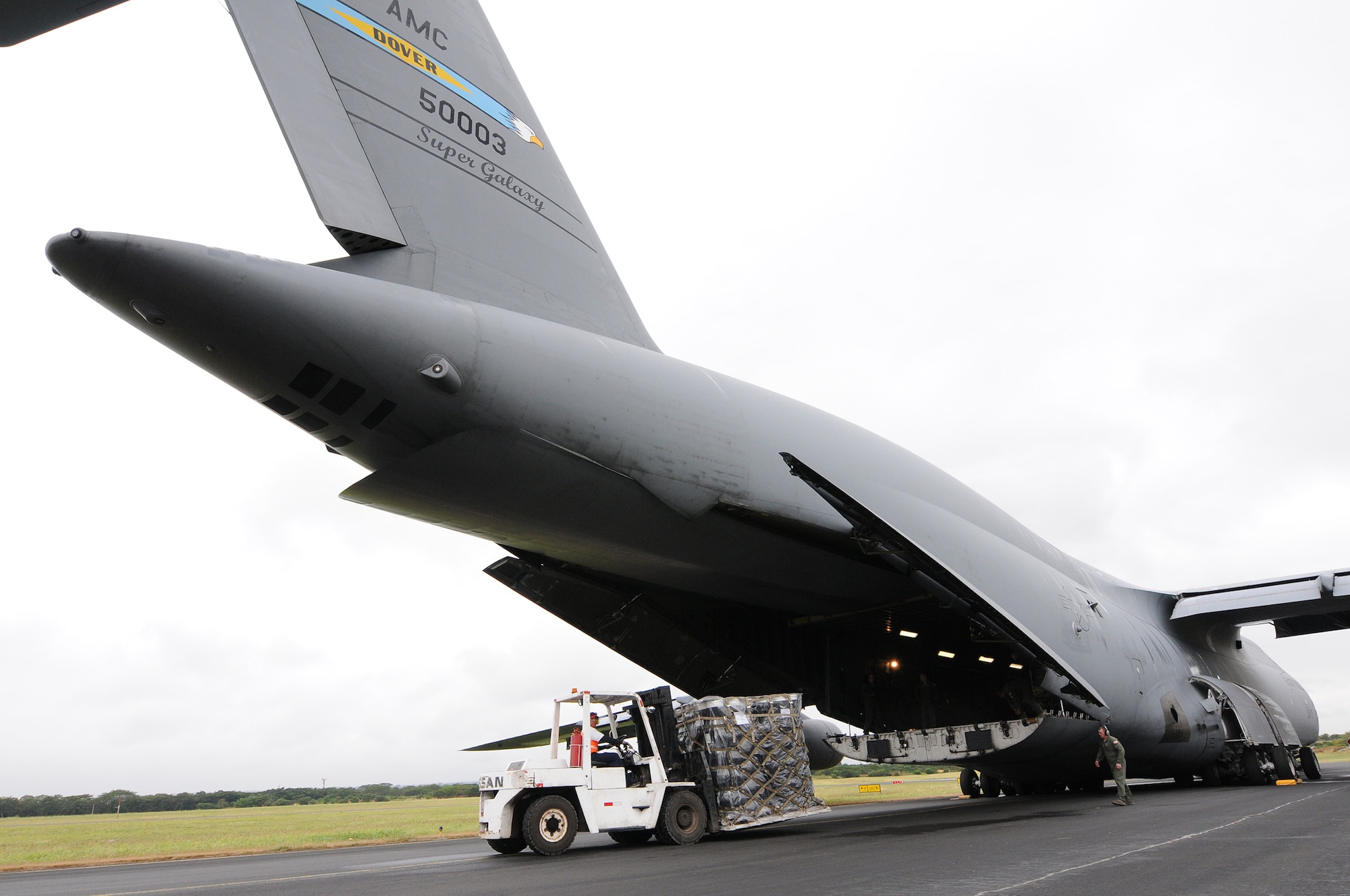 Reserve Airmen from the 512th Airlift Wing delivered humanitarian supplies to Nicaragua aboard a C-5M Super Galaxy Dec. 20, 2014 just in time for the Holidays. 125,000 pounds of food and educational equipment were airlifted to Nicaragua's Augusto C. Sandino International Airport in Managua. The massive delivery was made possible through the Denton Program, a Department of Defense humanitarian assistance transportation program that utilizes space available military air, surface and sea-lift assets. The supplies were provided to World Missions Outreach, which is an international nonprofit organization based in Nicaragua that provides food, education, medical and ministry services to the country's citizens.(U.S. Air Force photo/2nd Lt. Steve Lewis)