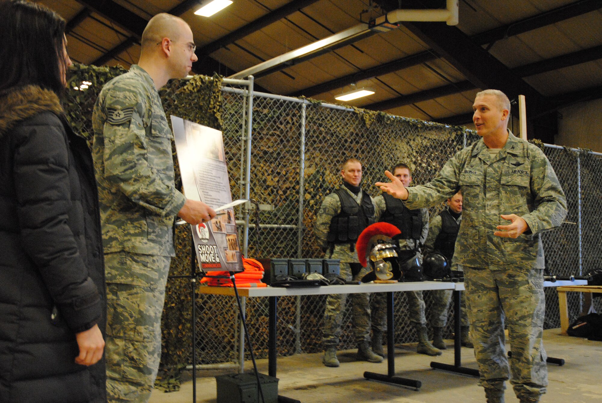 Col. Paul Bauman, 319th Air Base Wing commander, presents technical sergeant stripes to Staff Sgt. Christopher Giles, 319th Security Forces Squadron, Dec. 22, 2014, at a security forces training facility at Grand Forks Air Force Base, N.D. Stripes for Exceptional Performers (STEP) is a program where the Air Force releases a limited number of slots for promotion to enlisted members in the ranks of staff sergeant, technical sergeant and master sergeant. Giles was officially step promoted to his current rank Dec. 16, but was on leave and didn’t find out for approximately six days later. Some of his fellow 319th SFS defenders and his wife were among several people who took part in the surprise. (U.S. Air Force photo/Staff Sgt. Luis Loza Gutierrez)
