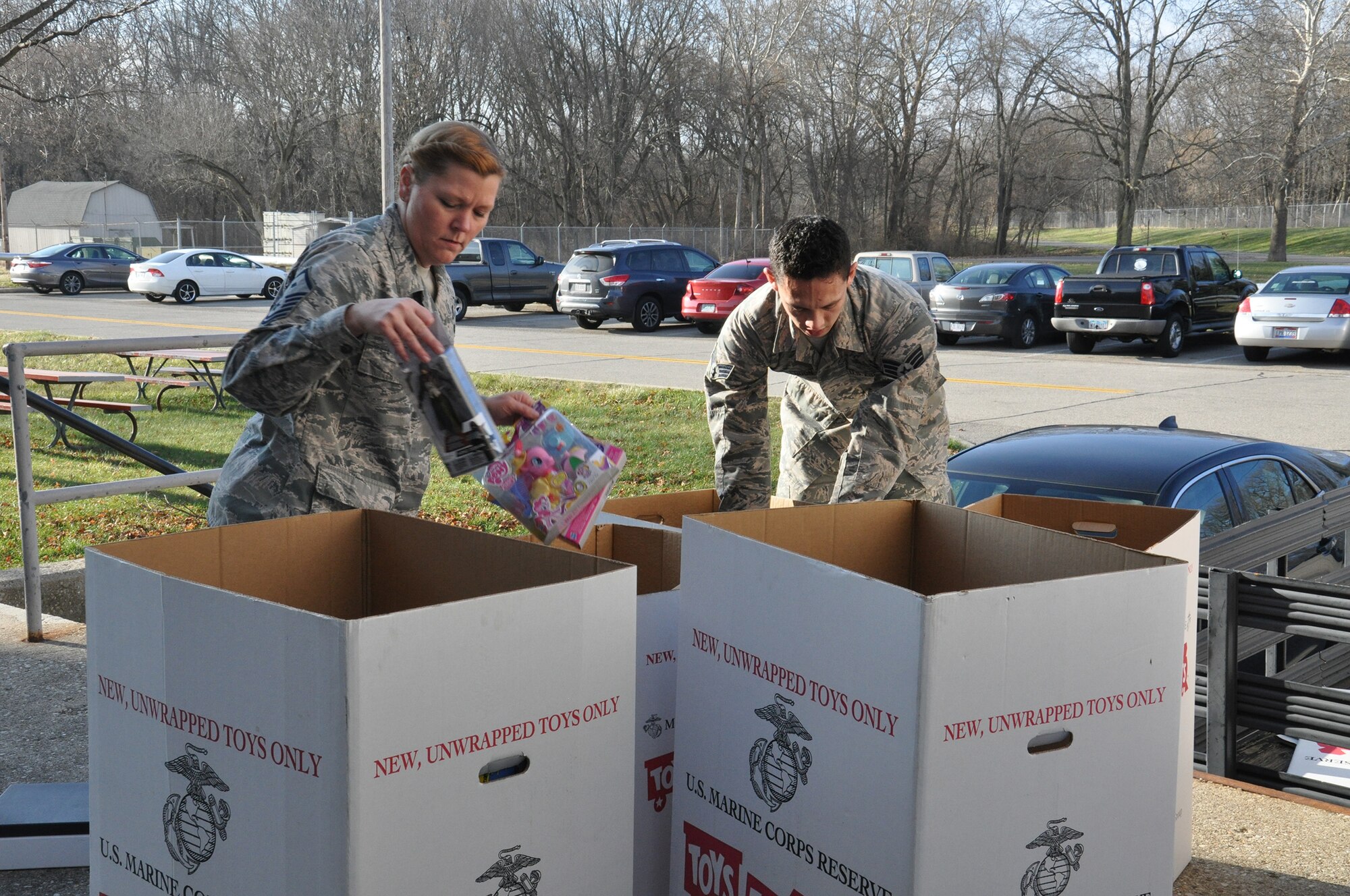 WRIGHT-PATTERSON AIR FORCE BASE, Ohio – Master Sgt. Glenda Marck, program manager, 445th Development and Training Flight/first sergeant, 89th Airlift Squadron, and Senior Airman Steven McClendon, 445th Force Support Squadron personnel journeyman, sort through donated toys before loading the boxes onto the back of a truck for the Toys for Tots campaign  Dec. 15, 2014. The 445th Airlift Wing collected 573 toys weighing more than 240 pounds. (U.S. Air Force photo/Stacy Vaughn)