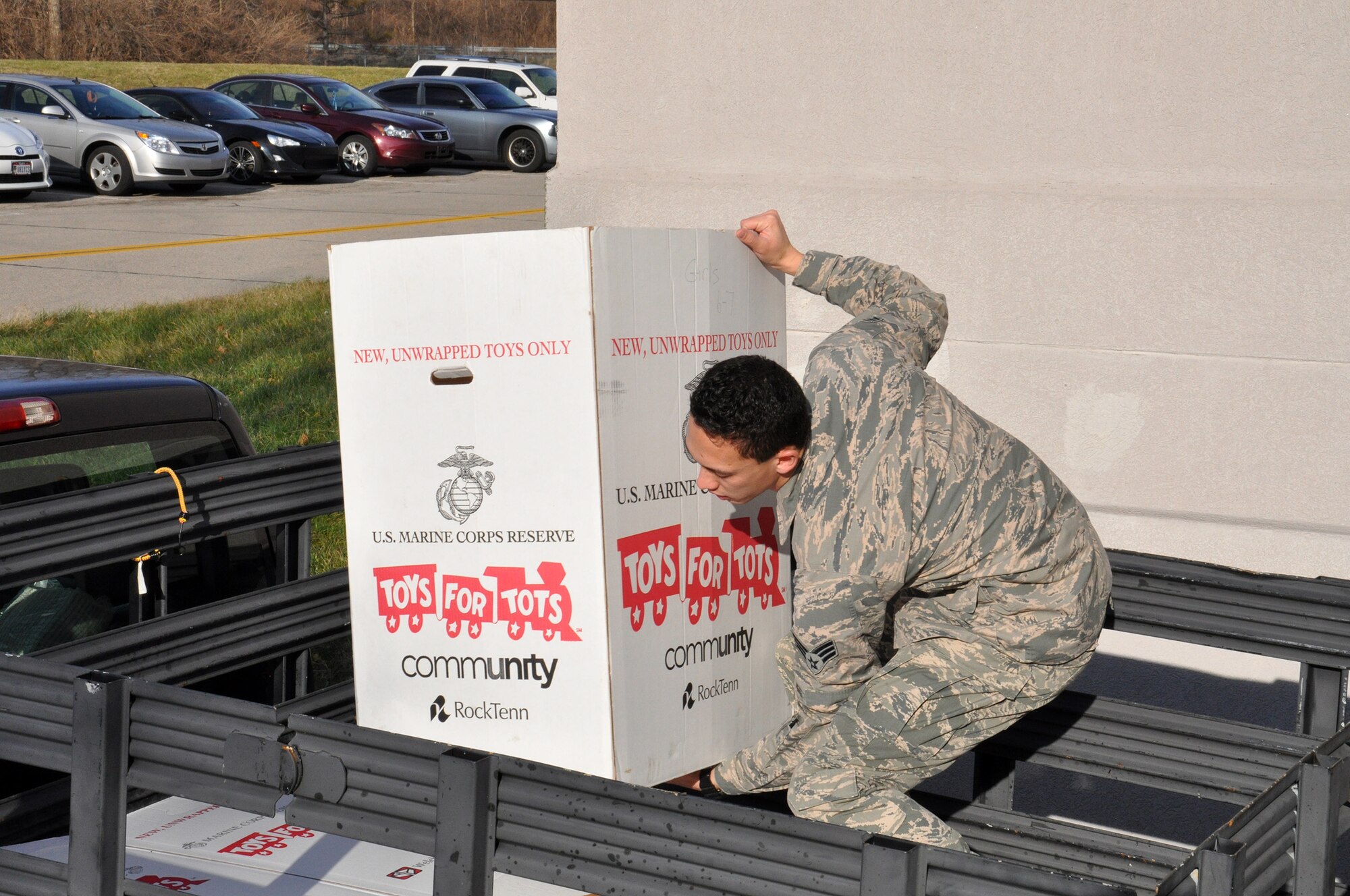 WRIGHT-PATTERSON AIR FORCE BASE, Ohio – Senior Airman Steven McClendon, 445th Force Support Squadron personnel journeyman, loads a box of toys onto the back of a truck for the Toys for Tots campaign Dec. 15, 2014. The 445th Airlift Wing collected 573 toys weighing more than 240 pounds. (U.S. Air Force photo/Stacy Vaughn)