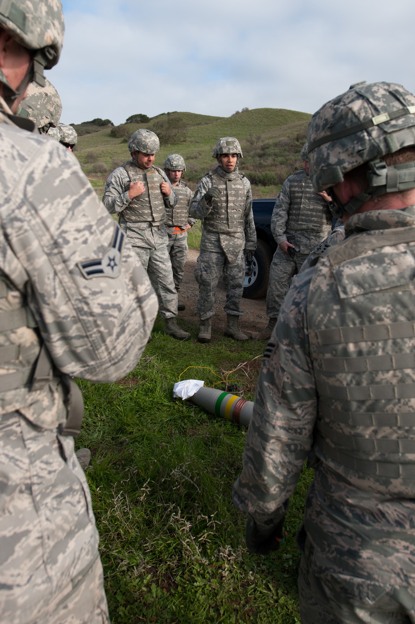 30th Logistics Readiness Squadron members gather with their convoy team members for an after action report after completing the first half of a simulated convoy mission Dec. 18, 2014, Vandenberg Air Force Base, Calif. Combat Operational Readiness Training (CORT) includes exercise preparation actions to properly prepare Vehicle Operations personnel for wartime duties. Airmen must possess the necessary skills to meet mission demands and predict future events if possible. The goal of this training is to ensure Airmen are able to operate and survive in a contingency or wartime environment as a team. (U.S. Air Force photo by Michael Peterson/Released)