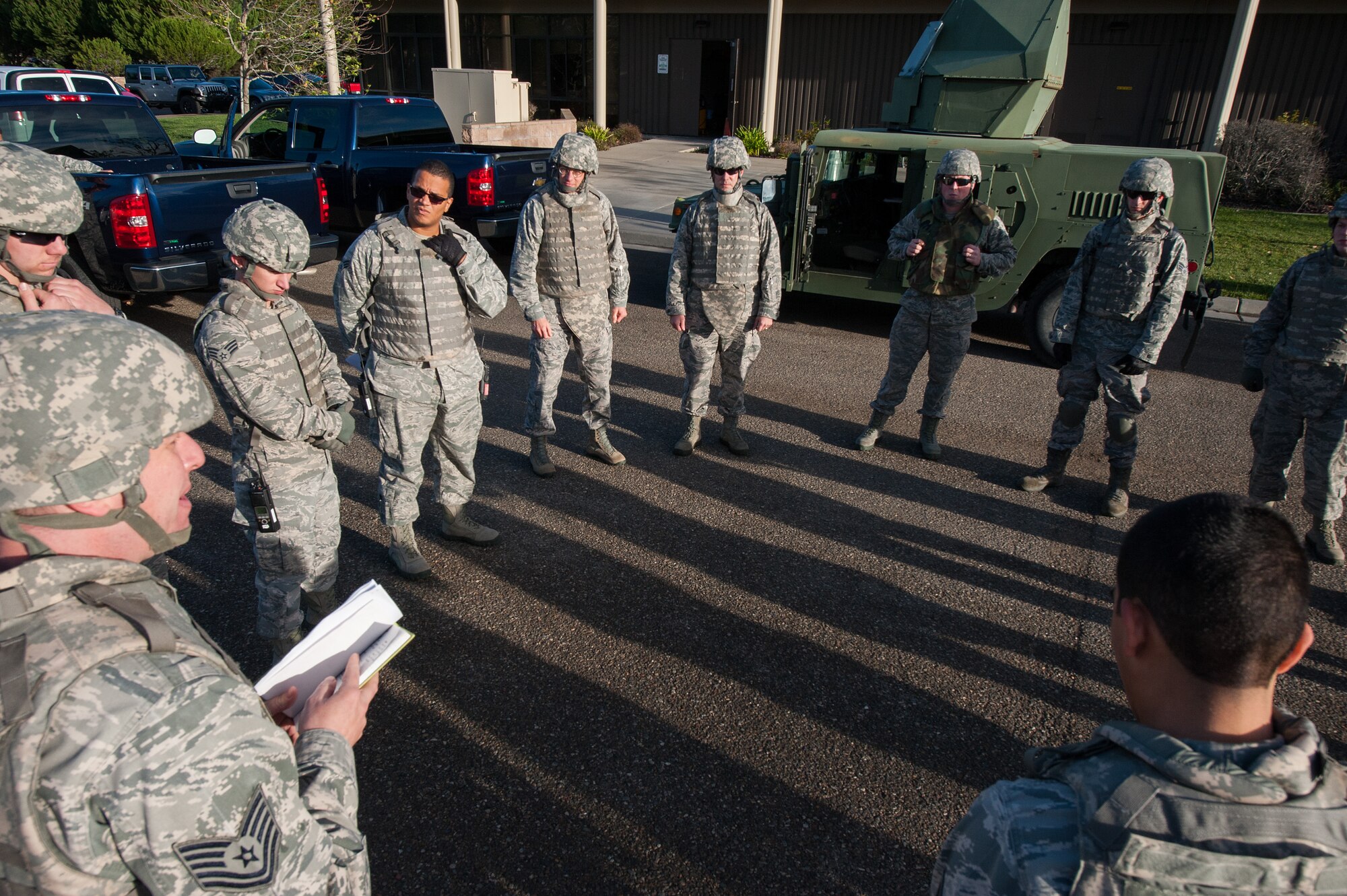 30th Logistics Readiness Squadron Airmen gather and receive their mission brief during Combat Operational Readiness Training Dec. 18, 2014, Vandenberg Air Force Base, Calif. CORT includes exercise preparation actions to properly prepare Vehicle Operations personnel for wartime duties. Airmen must possess the necessary skills to meet mission demands and predict future events if possible. The goal of this training is to ensure Airmen are able to operate and survive in a contingency or wartime environment as a team. (U.S. Air Force photo by Michael Peterson/Released)