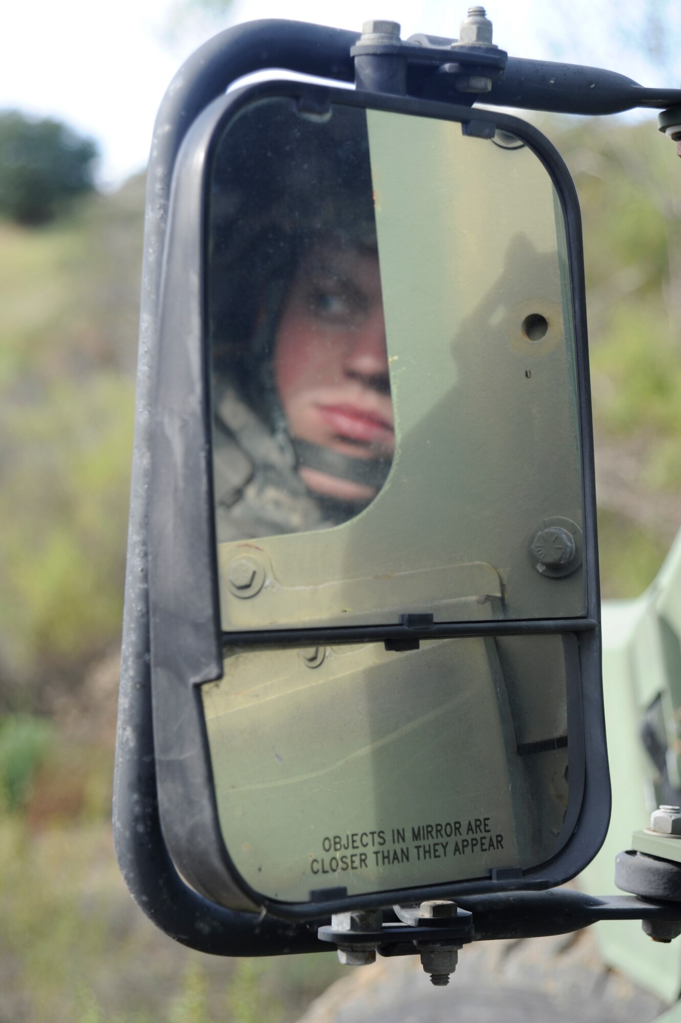 Senior Airman Logan Spencer 30th Logistics Readiness Squadron Vehicle Operations Journeyman, scans the area for suspicious activity as the convoy team prepares to move out for the second half of their training mission. Observation and awareness of ones surroundings play an integral part of convoy safety. About half of the 30th Logistics Readiness Squadron's Vehicle Operators have conducted convoys while deployed in support of contingency operations, some  multiple times. (U.S. Air Force photo by Airman 1st Class Ian Dudley/Released)