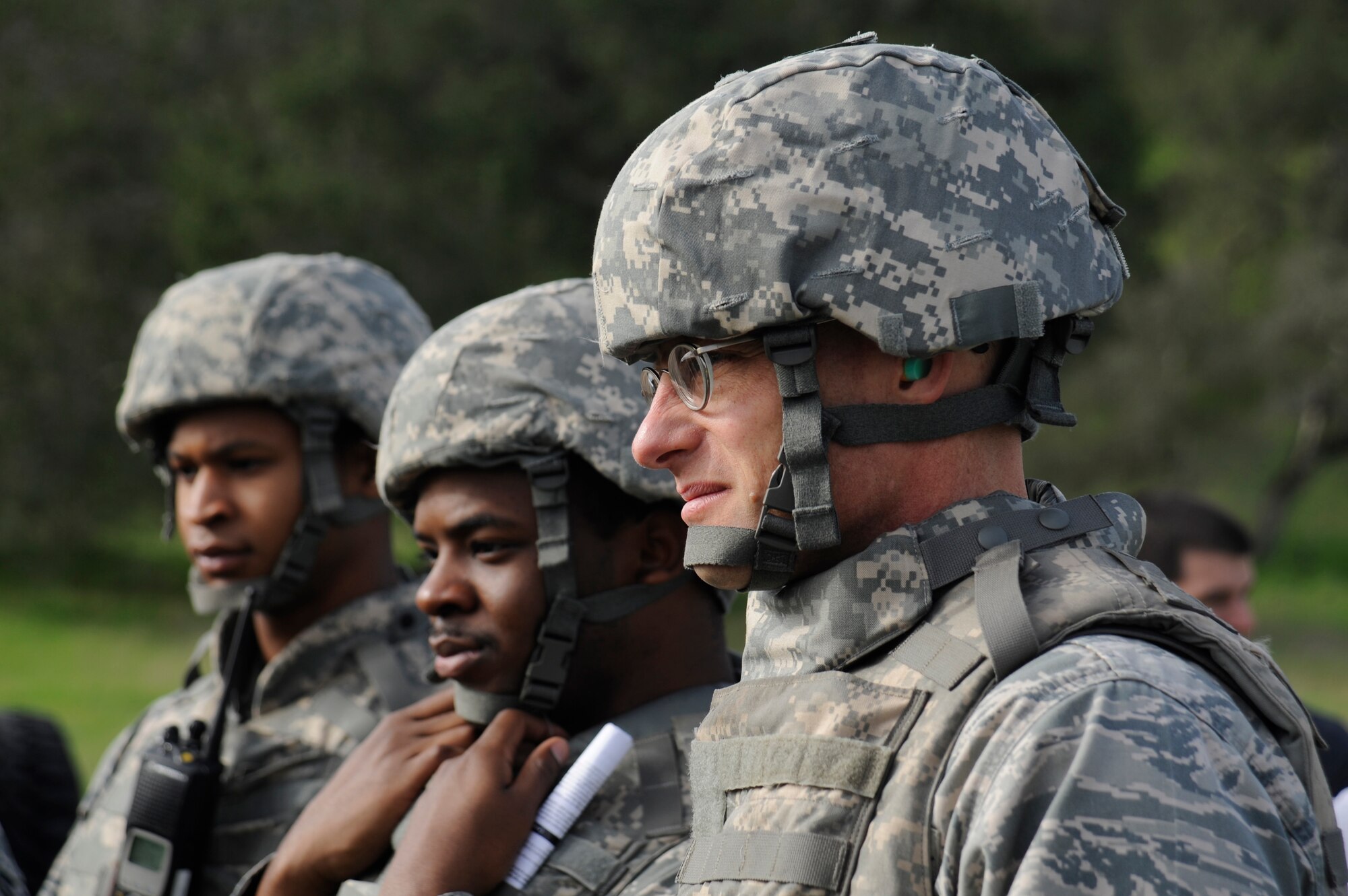 Col. Todd Schollars, 30th Mission Support Group commander, joins Airman First Class Eric Collins and Airman First Class Keanu Crouch, 30th Logistics Readiness Squadron Vehicle Operators, for an after action report after completing the first half of a simulated convoy mission Dec. 18, 2014, Vandenberg Air Force Base, Calif. Col. Schollars was embedded with the convoy team during their Combat Operational Readiness Training to gain first-hand experience with the intricacies of the 30 LRS mission, which falls under his command. (U.S. Air Force photo by Airman 1st Class Ian Dudley/Released)
