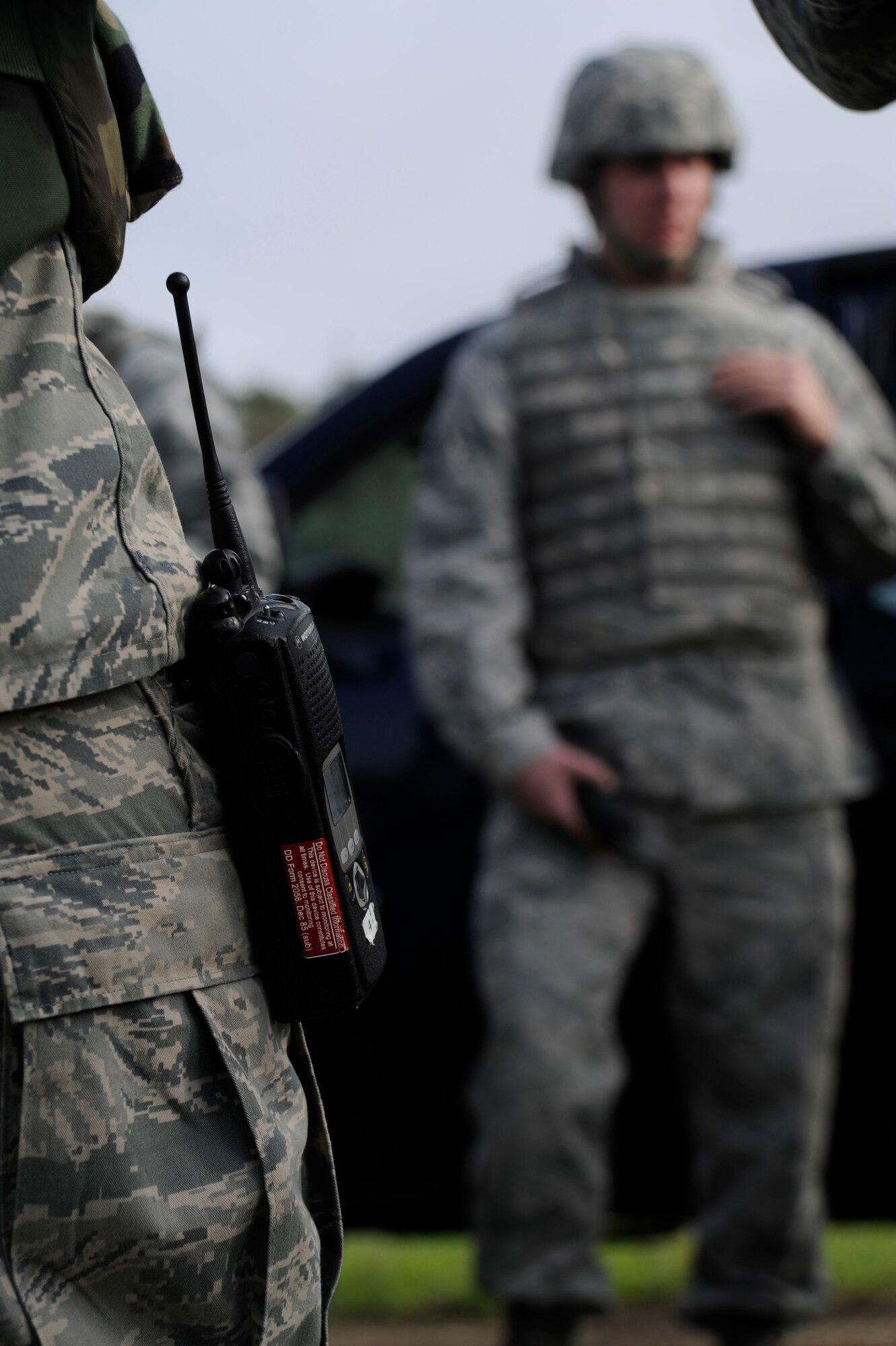 30th Logistics Readiness Squadron Airmen, equipped with hand-held radios, discuss their convoy operation during Combat Operational Readiness Training Dec. 18, 2014, Vandenberg Air Force Base, Calif. Communication is an essential part of any convoy mission and handheld radios are a common sight among team members. CORT includes exercise preparation actions to properly prepare Vehicle Operations personnel for wartime duties. Airmen must possess the necessary skills to meet mission demands and predict future events if possible. This training ensures personnel are able to operate and survive in a contingency or wartime environment as a team. (U.S. Air Force photo by Airman 1st Class Ian Dudley/Released)