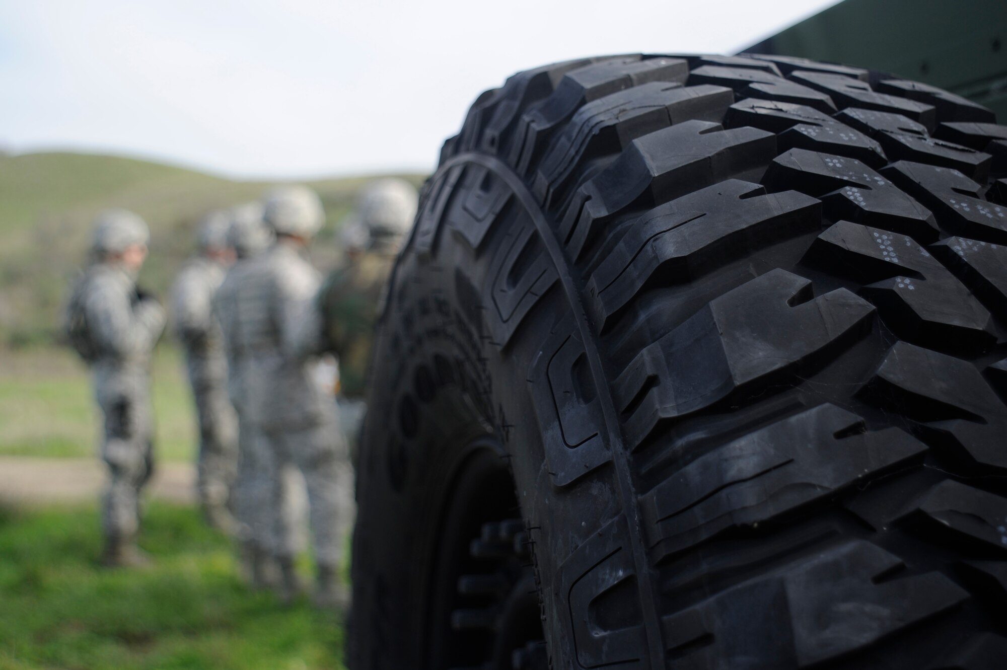 30th Logistics Readiness Squadron members gather with their convoy team members for an after action report after completing the first half of a simulated convoy mission  Dec. 18, 2014, Vandenberg Air Force Base, Calif. Combat Operational Readiness Training includes exercise preparation actions to properly prepare Vehicle Operations personnel for wartime duties. They must possess the necessary skills to meet mission demands and predict future events if possible. The goal of this training is to ensure Airmen are able to operate and survive in a contingency or wartime environment as a team. (U.S. Air Force photo by Airman 1st Class Ian Dudley/Released)