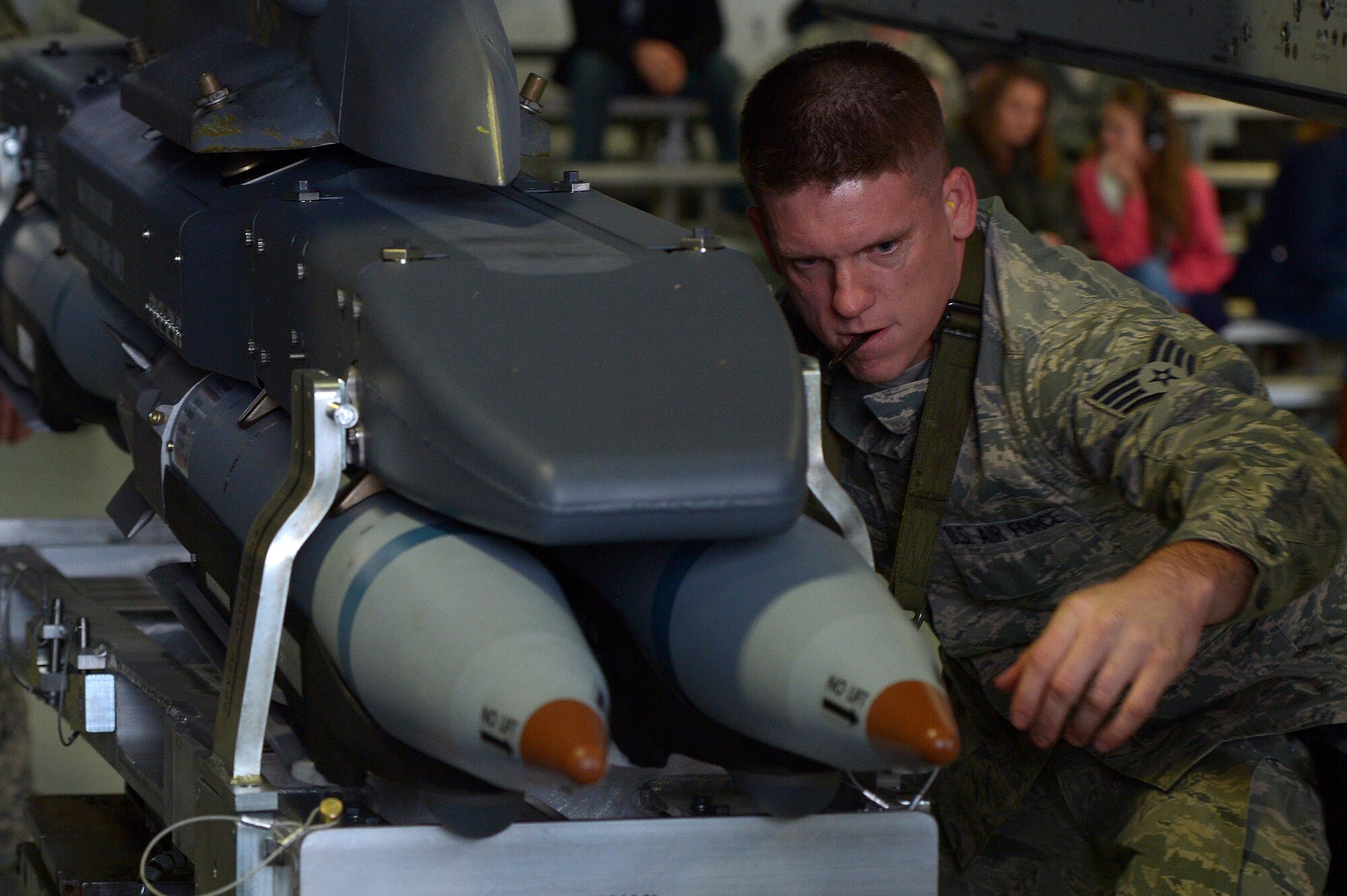 U.S. Air Force Staff Sgt. Joshua Lee, 20th Aircraft Maintenance Squadron weapons load crew member assigned to crew 55-07 “Shooters”, loads munitions onto an F-16CM Fighting Falcon during a weapons load crew of the quarter competition at Shaw Air Force Base, S.C., Dec. 22, 2014. The quarterly competition keeps Airmen sharp and prepared for deployment at a moment’s notice. (U.S. Air Force photo by Staff Sgt. Kenny Holston/Released)