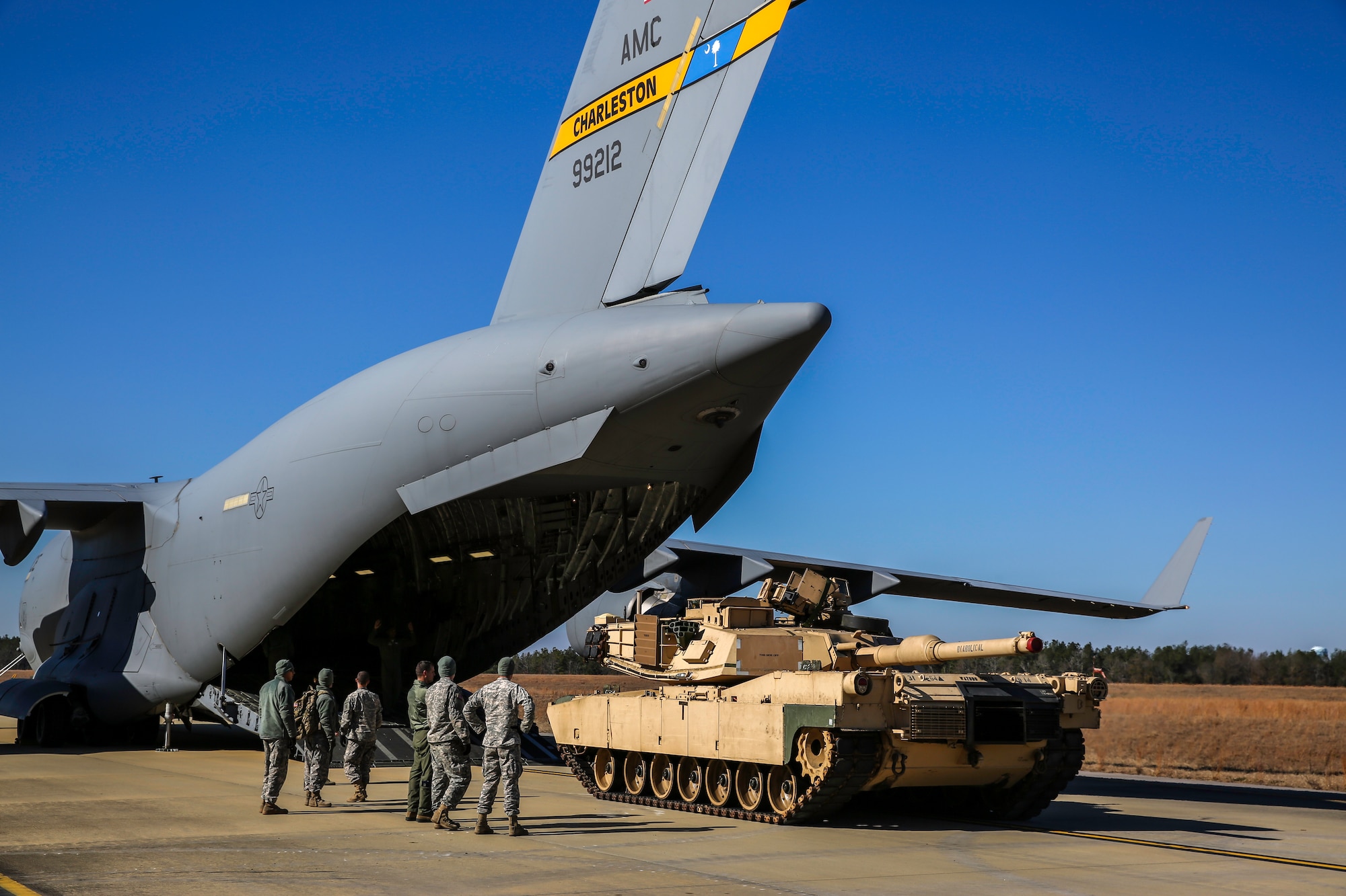 An Abrams M1A2 tank makes its way toward the ramp of a C-17 Globemaster III Dec. 11, 2014 at North Air Force Auxiliary Field in North, S.C. The tank movement was part of a two-day exercise which integrated C-17 air and ground crew training for 315th Airlift Wing Airmen stationed at Joint Base Charleston, S.C. as well as Soldiers from one of the 3rd Infantry Division’s Immediate Ready Companies stationed at Fort Stewart, Ga. Four C-17’s were used during the exercise to deploy and redeploy two Abrams M1A2 tanks, an M88 recovery vehicle and two M2A3 Bradley Fighting Vehicles. (U.S. Air Force photo by Tech. Sgt. Shane Ellis)