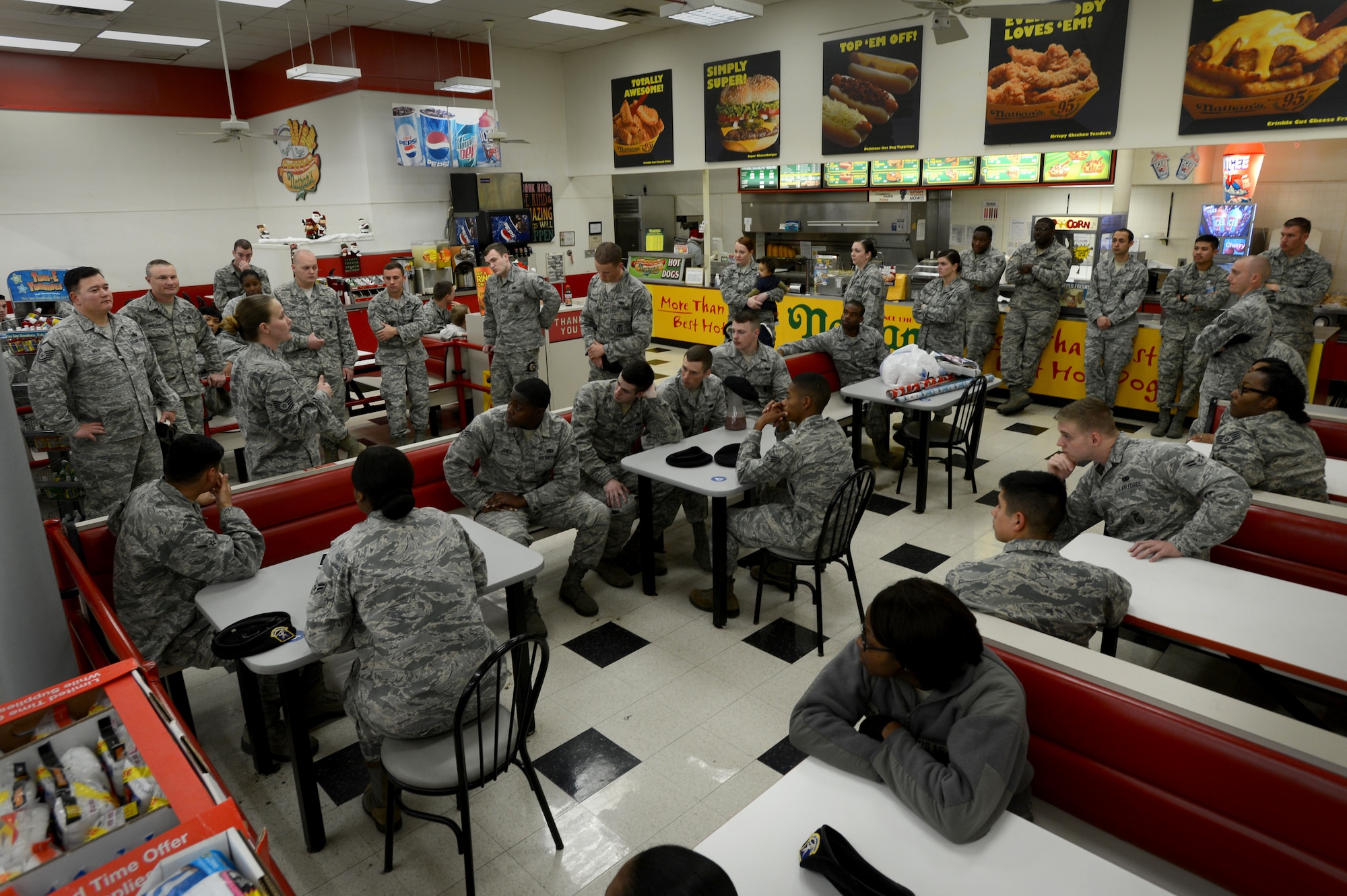 Airmen assigned to the 20th Security Forces Squadron are briefed before their participation in a “shop with a cop” event at Kmart in Sumter, S.C., Dec. 22, 2014. The 20th SFS raised approximately $2,000 for more than 30 kids of the John K. Crosswell Home For Children to buy holiday gifts. (U.S. Air Force photo by Senior Airman Jensen Stidham/Released) 