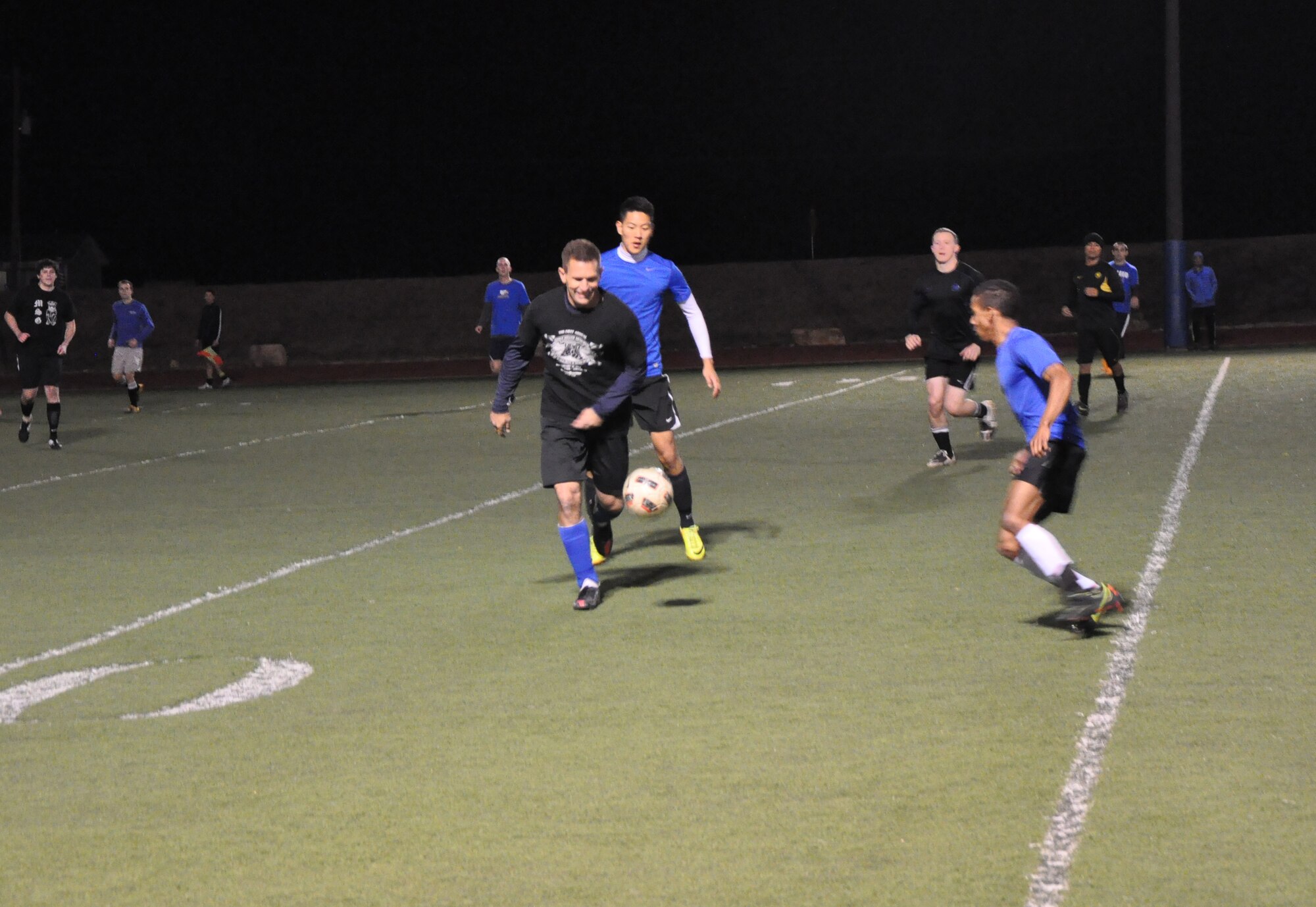 GOODFELLOW AIR FORCE BASE, Texas – Samuel L. Spooner III, 17th Training Wing Safety chief, dribbles a soccer ball during the intermural soccer championship at Mathis Fitness Center football field Dec. 18. Spooner and the 17th Mission Support Group Junkyard Dawgs played against the 315th Training Squadron Rattlers Team #1 for first and second place. (U.S. Air Force photo/ Senior Airman Joshua Edwards)