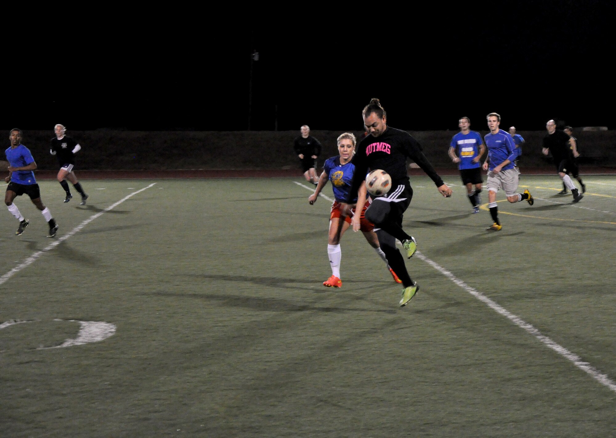 GOODFELLOW AIR FORCE BASE, Texas – Piero M. Munoz, 17th Force Support Squadron Youth Center lead program assistant, knees a soccer ball during the intermural soccer championship at Mathis Fitness Center football field Dec. 18. Munoz played for the 17th Mission Support Group Junkyard Dawgs, which placed second overall in the competition. (U.S. Air Force photo/ Senior Airman Joshua Edwards)