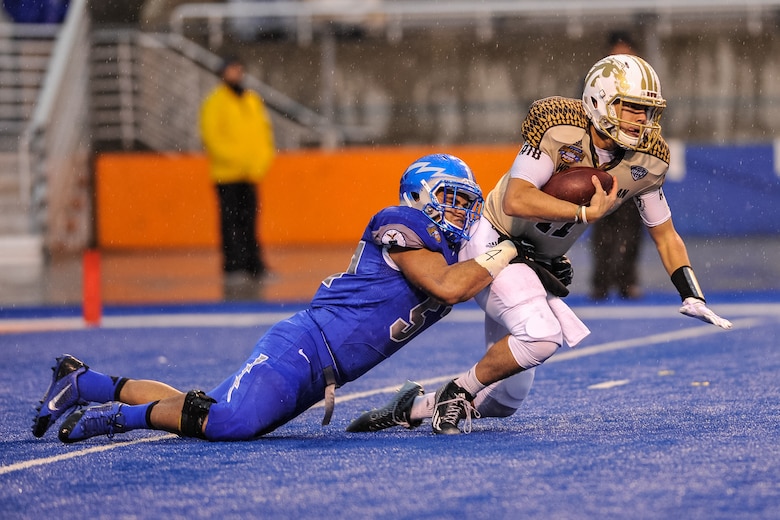 Air Force senior linebacker Jordan Pierce sacks Western Michigan quarterback Zach Terrell in the first half of the Famous Idaho Potato Bowl Dec. 20, 2014. Pierce, a native of Athens, Ga., had two sacks for 11 yards in the Falcons' 38-24 victory. (U.S. Air Force photo/Liz Copan)