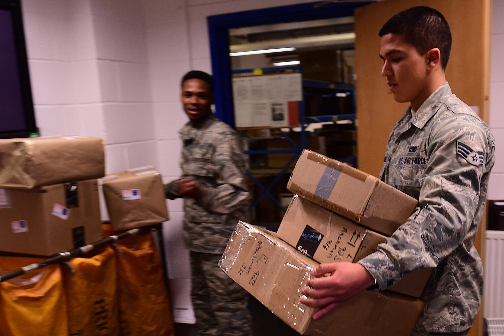 Senior Airman Jonathan Hernandez, 422nd Communication Squadron finance clerk, is preparing out-going parcels for the afternoon delivery truck, Dec. 2, 2014.  Mail is flown into London Heathrow Airport from around the world where personnel at the London Mail control activity are responsible for making sure all military mail is received. (U.S. Air Force photo by Tech. Sgt. Chrissy Best)