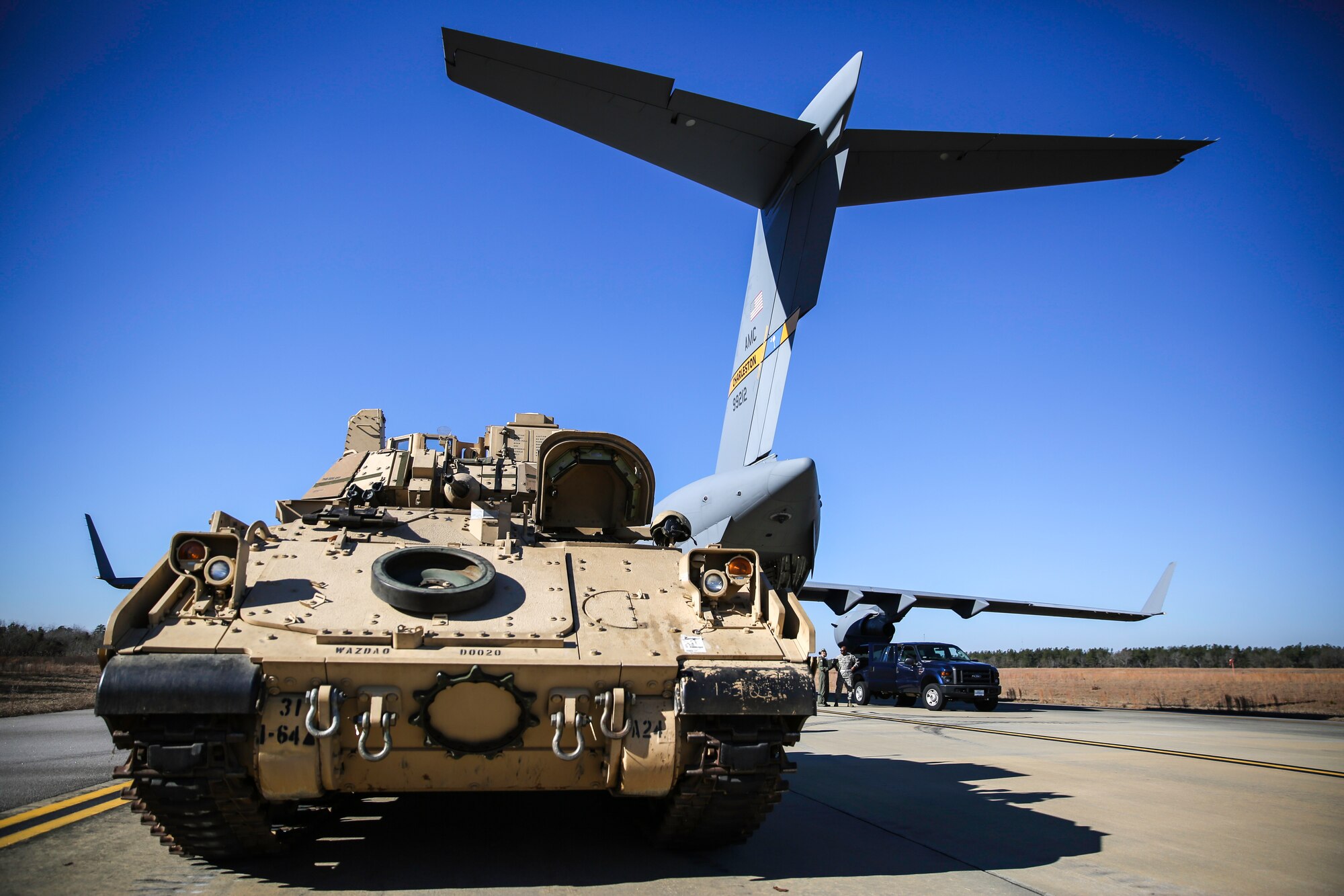 An M2A3 Bradley Fighting Vehicle sits on the ramp at North Air Force Auxiliary Field in North, S.C. Dec. 11, 2014. The vehicle was used as cargo during a two-day exercise which integrated C-17 air and ground crew training for 315th Airlift Wing Airmen stationed at Joint Base Charleston, S.C. as well as Soldiers from one of the 3rd Infantry Division’s Immediate Ready Companies stationed at Fort Stewart, Ga. Four C-17’s were used during the exercise to deploy and redeploy two Abrams M1A2 tanks, an M88 recovery vehicle and two M2A3 Bradley Fighting Vehicles. (U.S. Air Force photo by Tech. Sgt. Shane Ellis)