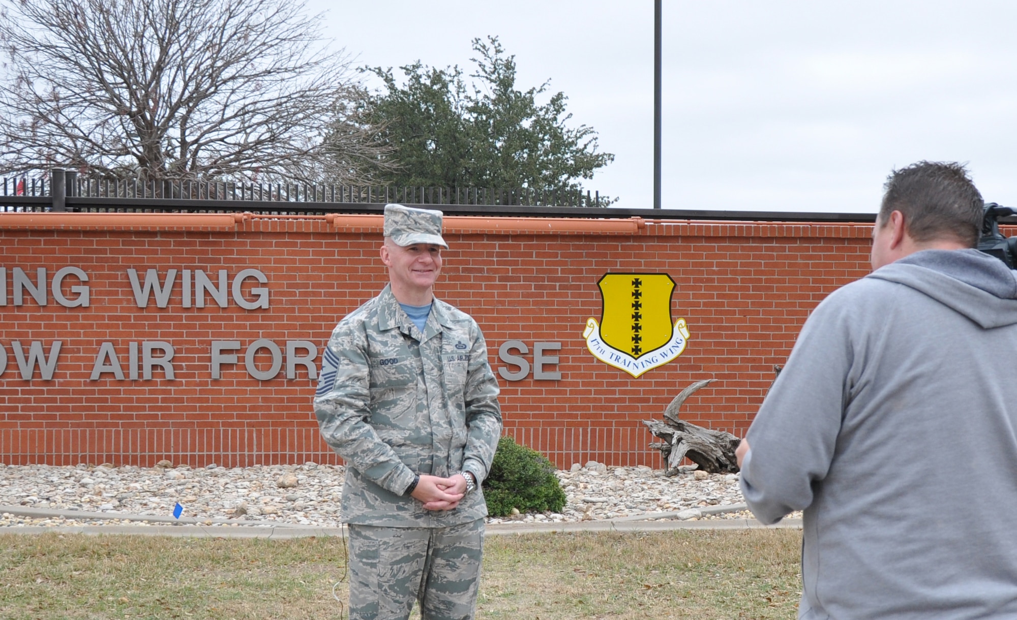 GOODFELLOW AIR FORCE BASE, Texas – Clint Dooley, K-SAN broadcaster, interviews Chief Master Sgt. Thomas F. Good, 17th Training Wing Command Chief, near the Jacobson Gate Dec. 19. Dooley asked Good about his holiday preferences. (U.S. Air Force photo/ Senior Airman Joshua Edwards)