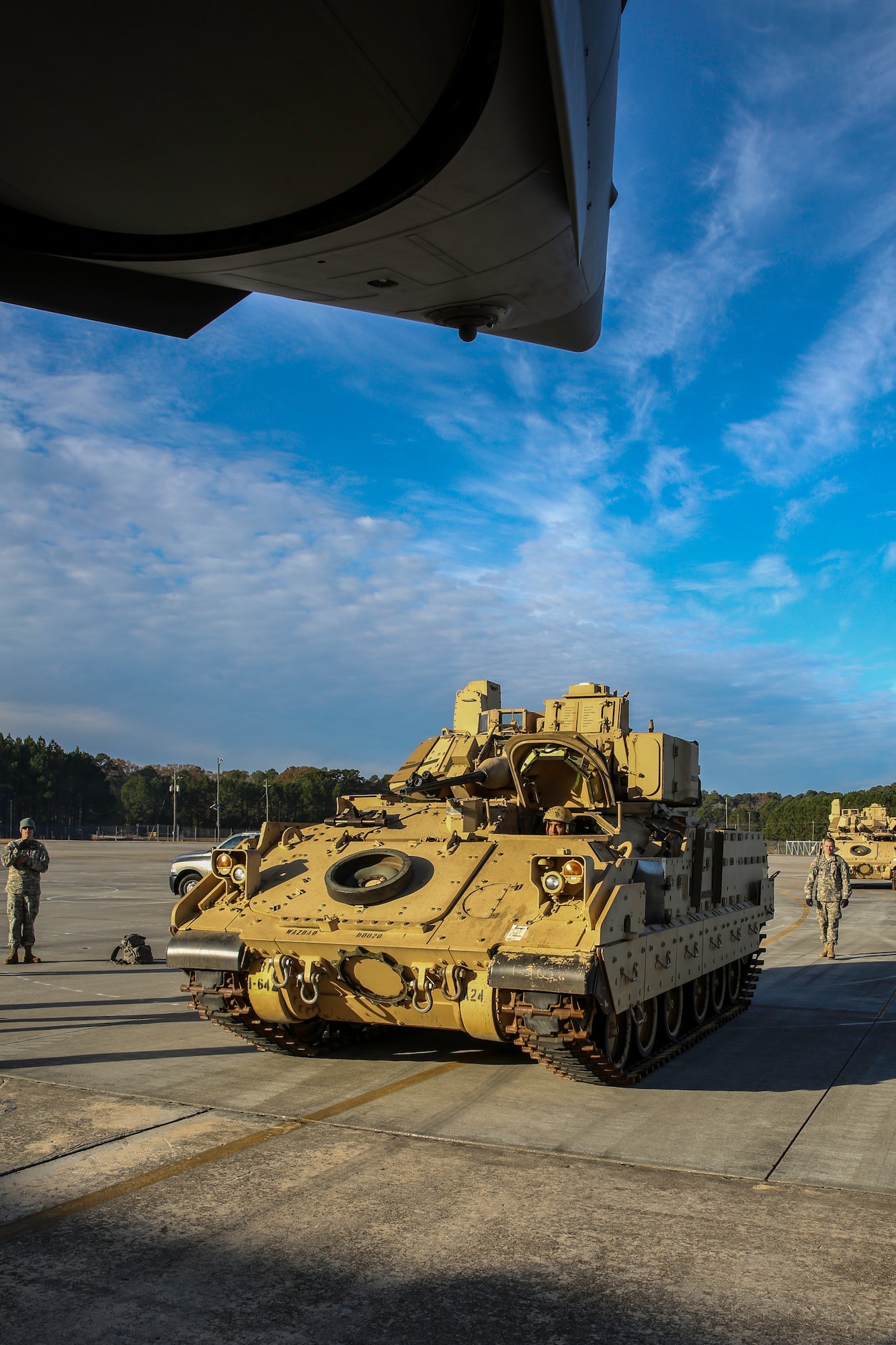 An M2A3 Bradley Fighting Vehicle makes a slow approach toward the ramp of a C-17 Globemaster III Dec. 11, 2014 at Hunter Army Airfield, Ga. The vehicle was used as cargo during a two-day exercise which integrated C-17 air and ground crew training for 315th Airlift Wing Airmen stationed at Joint Base Charleston, S.C. as well as Soldiers from one of the 3rd Infantry Division’s Immediate Ready Companies stationed at Fort Stewart, Ga. Four C-17’s were used during the exercise to deploy and redeploy two Abrams M1A2 tanks, an M88 recovery vehicle and two M2A3 Bradley Fighting Vehicles. (U.S. Air Force photo by Tech. Sgt. Shane Ellis)