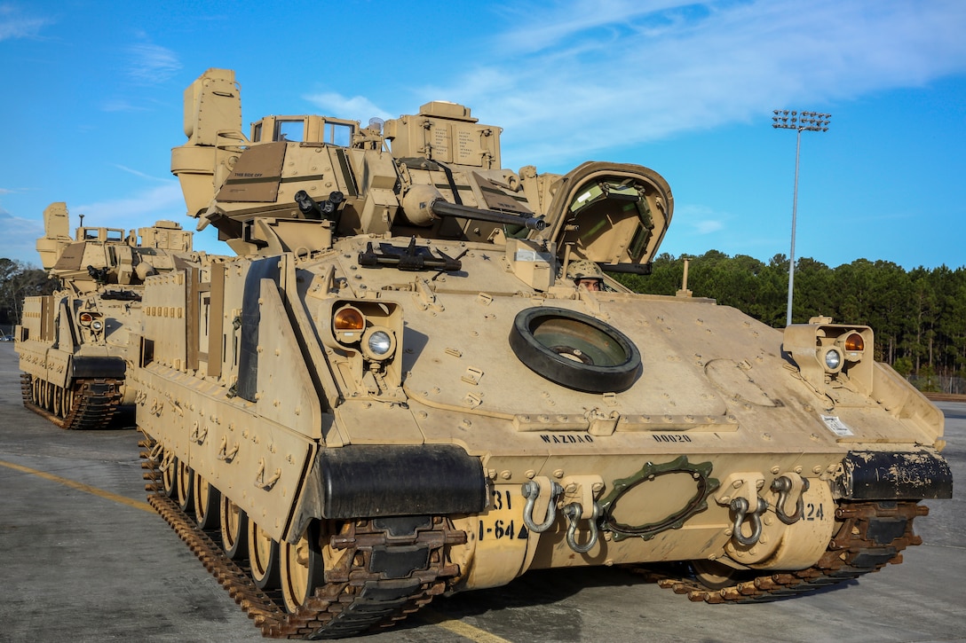 Two M2A3 Bradley Fighting Vehicles stand ready for upload at Hunter Army Airfield, Ga. Dec. 11, 2014. The vehicles were used as cargo during a two-day exercise which integrated C-17 air and ground crew training for 315th Airlift Wing Airmen stationed at Joint Base Charleston, S.C. as well as Soldiers from one of the 3rd Infantry Division’s Immediate Ready Companies stationed at Fort Stewart, Ga. Four C-17’s were used during the exercise to deploy and redeploy two Abrams M1A2 tanks, an M88 recovery vehicle and two M2A3 Bradley Fighting Vehicles. (U.S. Air Force photo by Tech. Sgt. Shane Ellis)
