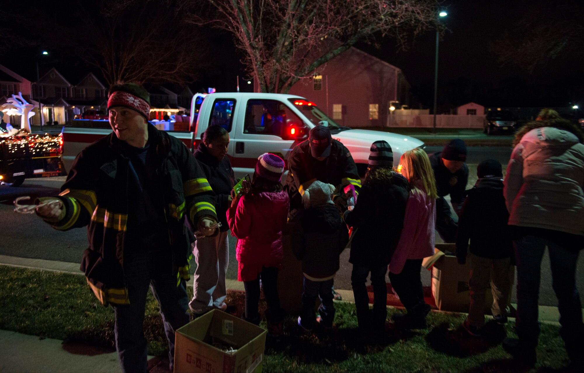 Joint Base McGuire-Dix-Lakehurst Fire Fighters hand out candy canes and small toys to the local children for Christmas, Dec. 18, 2014. The JB MDL Fire Department Candy Cane Run is an annual event where fire fighters hand out candy canes to spread holiday cheer and raise morale. (U.S. Air Force photo by Airman 1st Class Joshua King/Released)