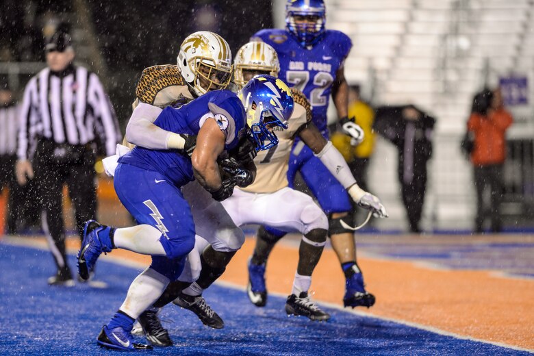 Air Force running back D.J. Johnson rushes past a Western Michigan defender for a touchdown in the 4th quarter of the Dec 20, 2014, Famous Idaho Potato Bowl in Boise, Idaho. Johnson had 20 rushes for 86 yards and a touchdown in Air Force's 38-24 victory. (U.S. Air Force photo/Liz Copan)