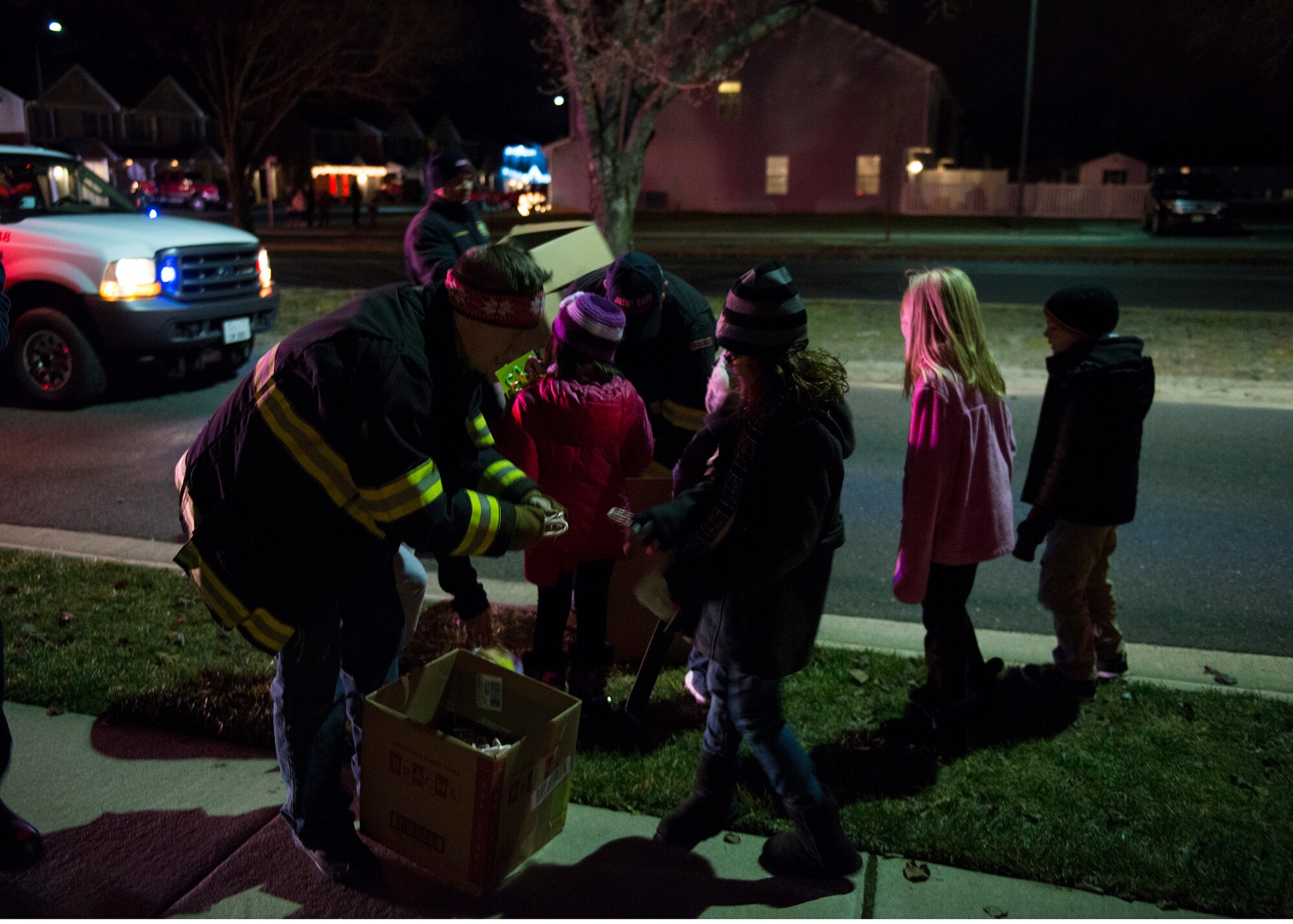 Joint Base McGuire-Dix-Lakehurst fire fighters hand out candy canes and small toys to the local children for Christmas, Dec. 18, 2014. The JB MDL Fire Department Candy Cane Run is an annual event where fire fighters hand out candy canes to spread holiday cheer and raise morale. (U.S. Air Force photo by Airman 1st Class Joshua King/Released)