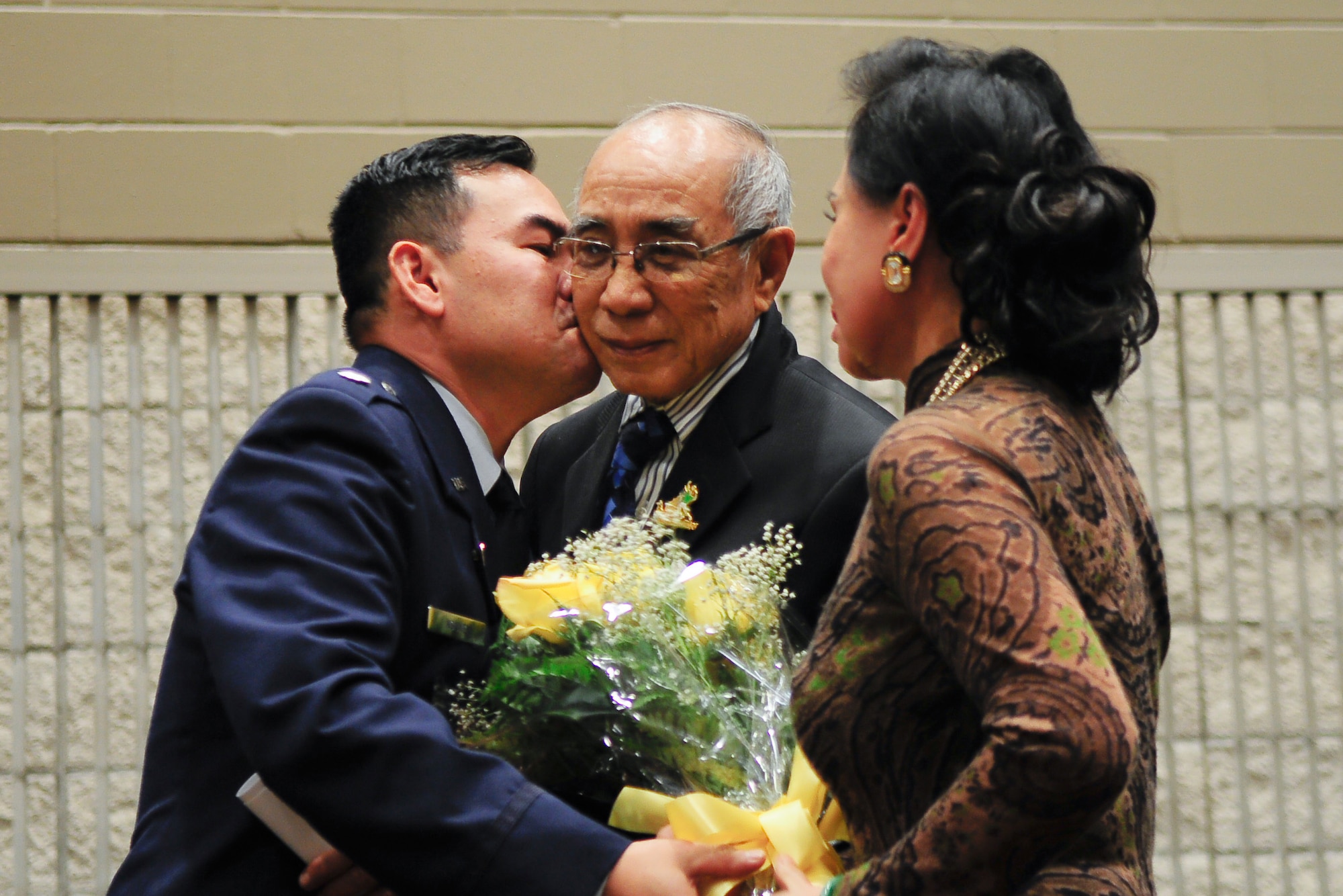 Air Force Lt. Col. Don Nguyen, assistant director of operations for the 273rd Information Operations Squadron (IOS), Texas Air National Guard, with his parents, Phuoc and Mai Nguyen, during his retirement ceremony in San Antonio, Nov. 23, 2014. Nguyen retired after 27 years of military service, including time with the Texas Army and Air National Guards. (U.S. Air National Guard photo by Tech. Sgt. Eric L. Wilson / Released) 141123-Z-IT549-003