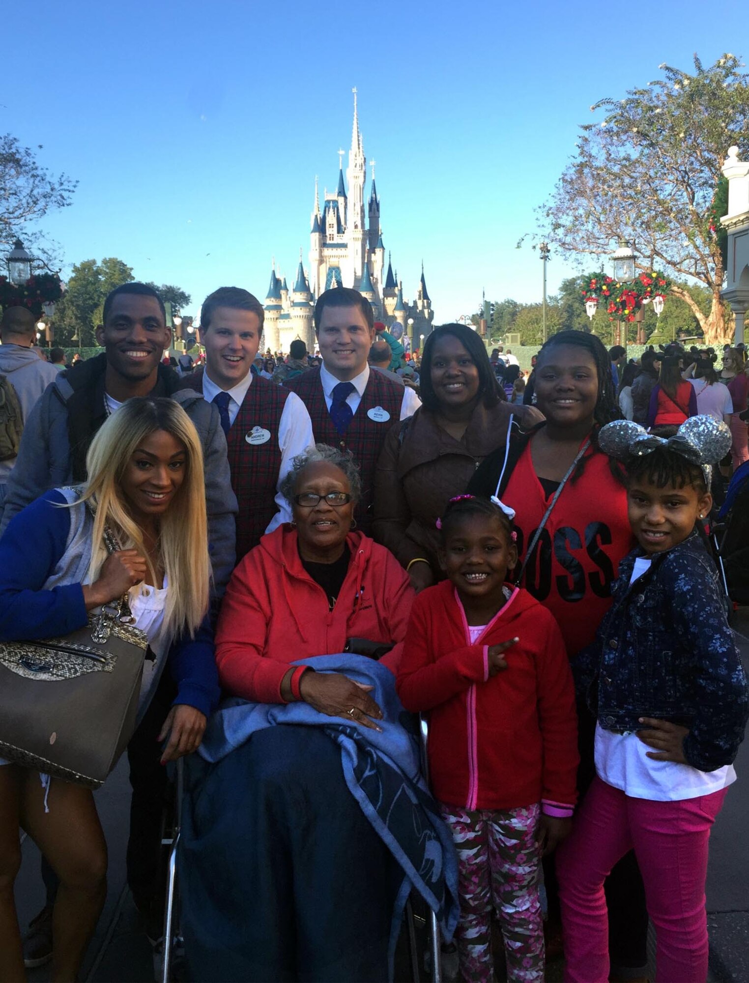 (Front row, second from left) Frenzella Bolden, 22nd Force Support Squadron child development center program assistant, poses with her family member and Disney employees, Dec. 10, 2014, at Walt Disney World in Orlando, Fla. Bolden was chosen by ABC to be highlighted as an outstanding caregiver after adopting and raising six children and working at the McConnell Air Force Base, Kan. child development center for over seven years. (Courtesy photo)