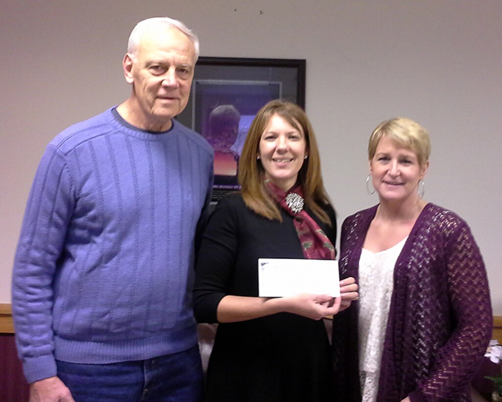 Jerry O’Neill (left), Executive Officer, Niagara County Builders Association, and Kristin Savard (right), President, Niagara County Builders Association present Holly Curcione (center), Niagara Falls Air Reserve Station Friends of Family Support Treasurer with a check of two hundred fifty dollars for the Friends of Family Support Association (FFSA) at the Niagara Air Base on December 17, 2014. The Niagara County Builders Association (NCBA) has been a supporter of the FFSA for several years and is a trade association representing home building and remodeling contractors and related businesses in Niagara County, New York. The NCBA has served the home building and remodeling industry in Niagara County since 1945. (U.S. Air Force photo by Megan Calero)