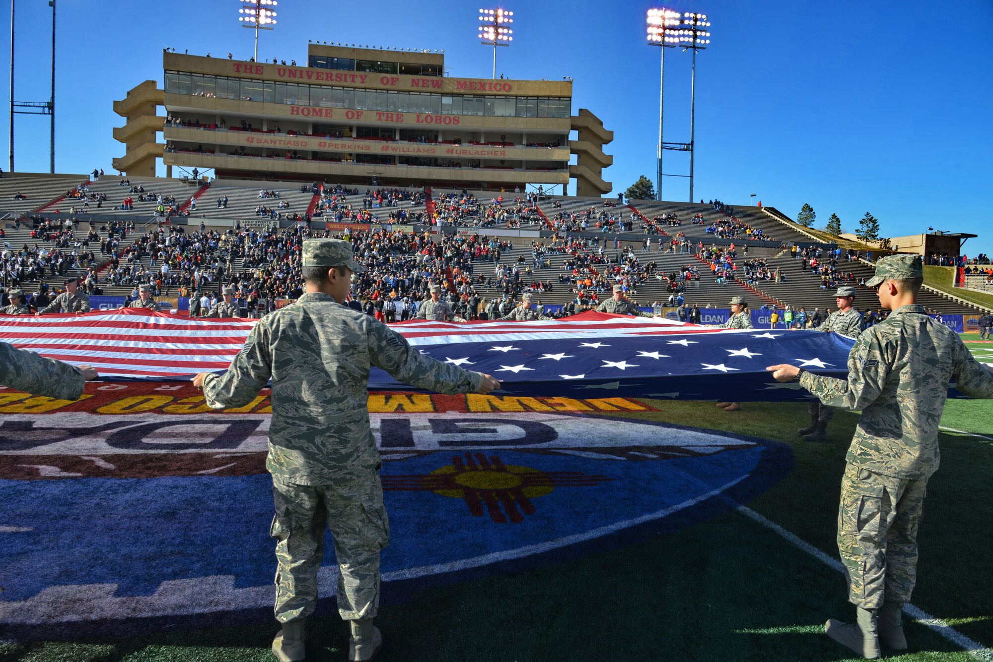 Kirtland Airmen unfurl a large American flag during the national anthem at the New Mexico Bowl Dec. 20. The game, in which Utah State University defeated the University of Texas-El Paso 21-6, took place at the University of New Mexico's Branch Field. (Photo by Ken Moore)
