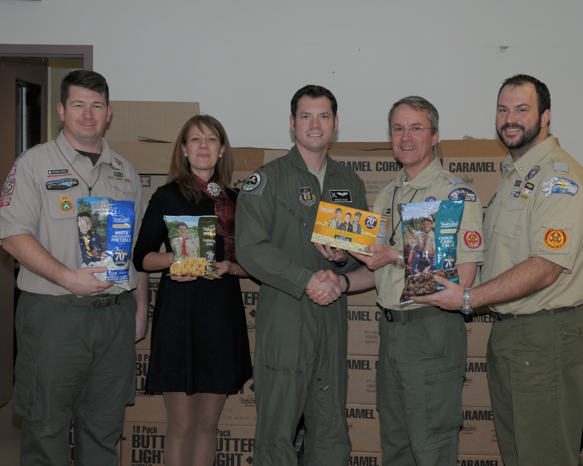 (L to R) Patrick Covell, Boy Scouts Greater Niagara Frontier Council, District Director, Holly Curcione, Niagara Air Reserve Station Friends of Family Support, Treasurer, 1Lt. Brian Haun, 328th Airlift Squadron C-130 Pilot, Russell Etzenhouser, Boy Scouts Greater Niagara Frontier Council CEO, and Justin King, Boy Scouts Greater Niagara Frontier Council, Finance and Marketing Director display the many different delicious varieties of popcorn that are donated to the troops at the Niagara Falls Air Reserve Station, N.Y. on December 17, 2014. The popcorn will be made available to all military members at the base for the holiday season and beyond. (U.S. Air Force photo by Peter Borys)