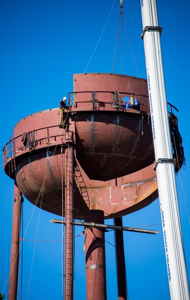 A contractor shouts directions to a crane's boom operator from high atop a new water tower being built at Duke Field, Fla.  The new water tower will support water distribution capacity for future development planned for Duke's west side.  (U.S. Air Force photo/Tech. Sgt. Jasmin Taylor)