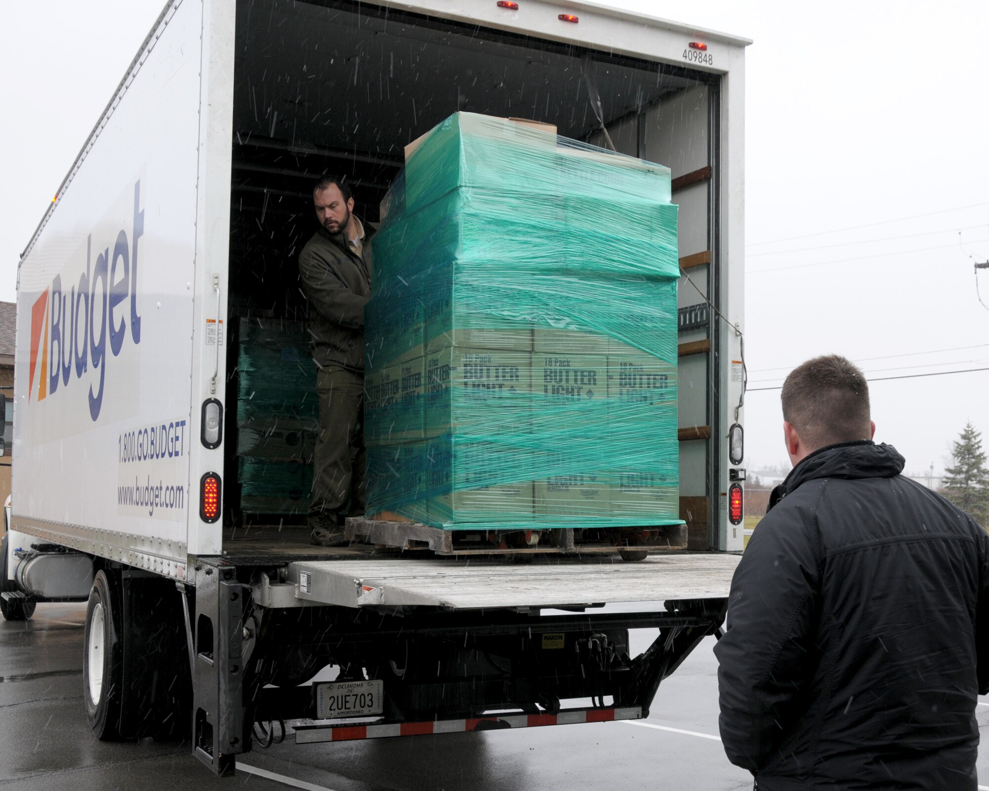 Justin King (left), Finance and Marketing Director, Boy Scouts Greater Niagara Frontier Council unloads a pallet full of gourmet popcorn while Patrick Covell Boy Scouts District Director gets ready to receive it at the Niagara Falls Air Reserve Station, N.Y. on December 17, 2014. Over 1,000 packages of gourmet caramel corn, kettle corn, chocolate and butter popcorns were delivered to the base as part of the popcorn for military program. (U.S. Air Force photo by Peter Borys)