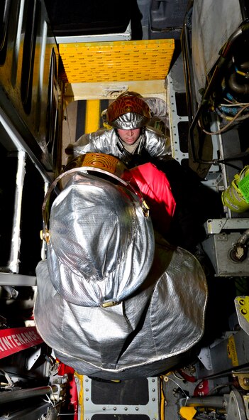 Senior Airman Nicholas Altobelli (foreground) and Staff Sgt. Robert Casey (background), 2nd Civil Engineer Squadron firefighters lower a simulated casualty from a B-52H Stratofortress during an aircrew egress exercise on Barksdale Air Force Base, La., Dec. 22, 2014. During the exercise firefighters help egress aircrew in under 90 seconds to increase chances of survival. (U.S. Air Force photo/Airman 1st Class Mozer O. Da Cunha)