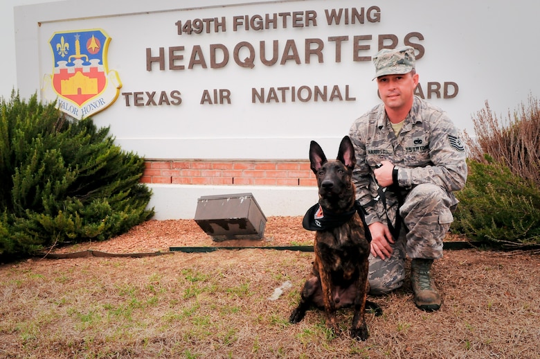 Tech. Sgt. Brandon M. Harrist, an aircraft electrical and environmental systems craftsman assigned to the 149th Maintenance Squadron, Texas Air National Guard with DDexter, a military working dog in training, which he is fostering as part of the Department of Defense?s Military Working Dog Breeding Program, at Joint Base San Antonio ? Lackland, Texas, Nov. 20, 2014. Harrist is a member of the 149th Fighter Wing, Texas Air National Guard, which is headquartered at JBSA-Lackland. (U.S. Air National Guard photo by Senior Master Sgt. Miguel Arellano / Released)
