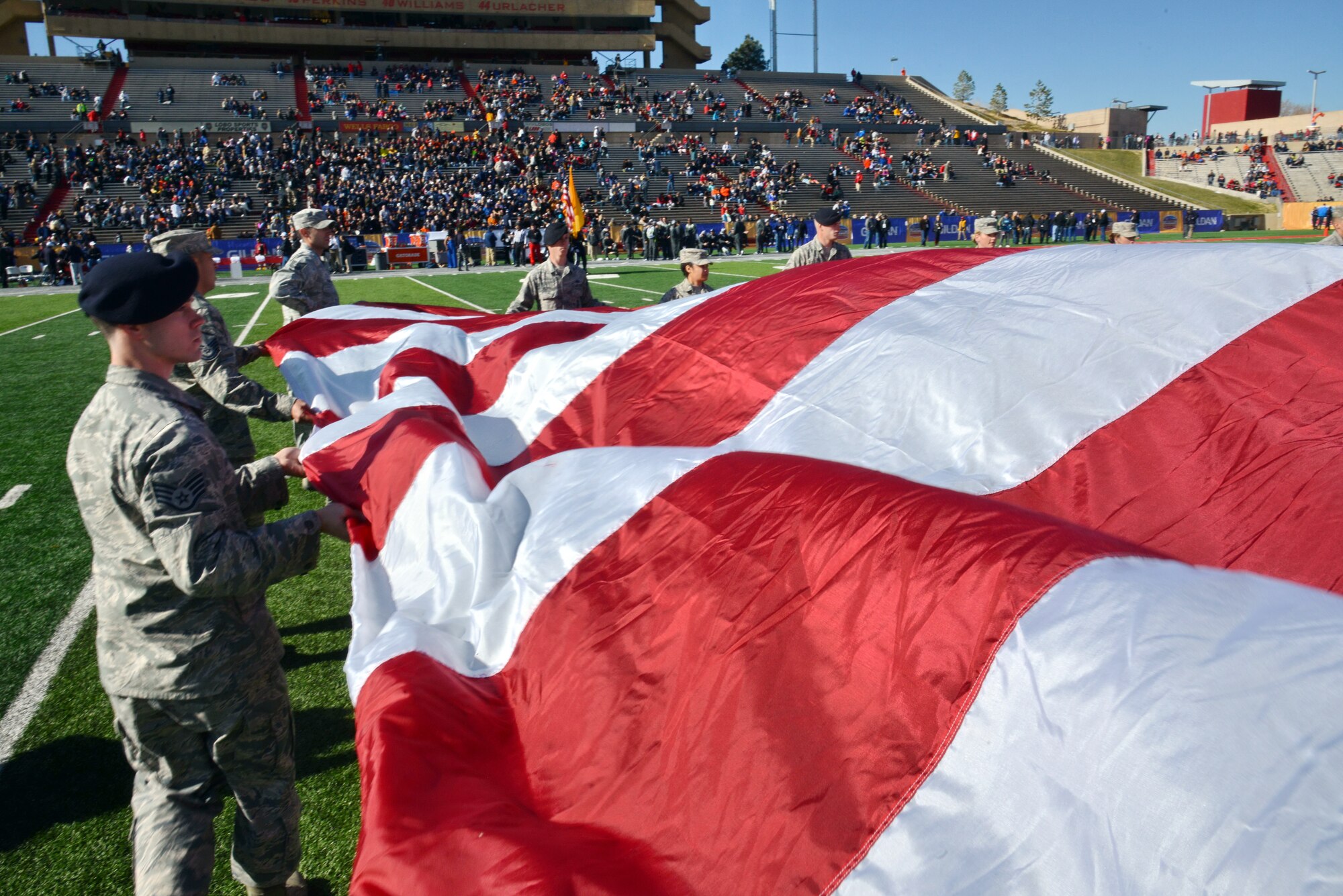 Kirtland Airmen unfurl a giant American flag during the national anthem at the New Mexico Bowl Dec. 20. The game, in which Utah State University defeated the University of Texas-El Paso 21-6, took place at the University of New Mexico's Branch Field. (Photo by Ken Moore)
