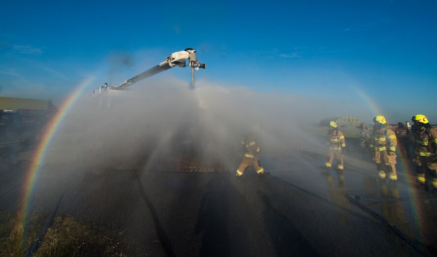 Firefighters from the 39th Civil Engineer Squadron Incirlik Fire Emergency Services, simulate decontamination processes during an emergency response exercise Dec. 16, 2014, at Incirlik Air Base, Turkey. Decontamination training is vital to ensure responders and aware of procedures if they were to be exposed to hazardous chemicals during a real world emergency. (U.S. Air Force photo by Airman Cory W. Bush/Released)