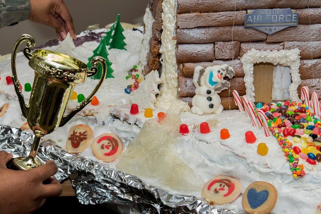 The 307th Operations Support Squadron Aircrew Flight Equipment shop takes the trophy for the best Ginger Bread House during a competition on Dec. 19, 2014, Barksdale Air Force Base, La. The competition is a holiday tradition for squadron and the winner is presented a trophy and gift bag. (U.S. Air Force photo by Master Sgt. Greg Steele/Released)