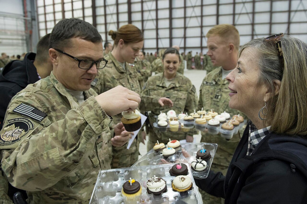 Deanie Dempsey hands out donated cupcakes after a USO show in Bagram Airfield, Afghanistan, Dec. 9, 2014. DoD photo by D. Myles Cullen