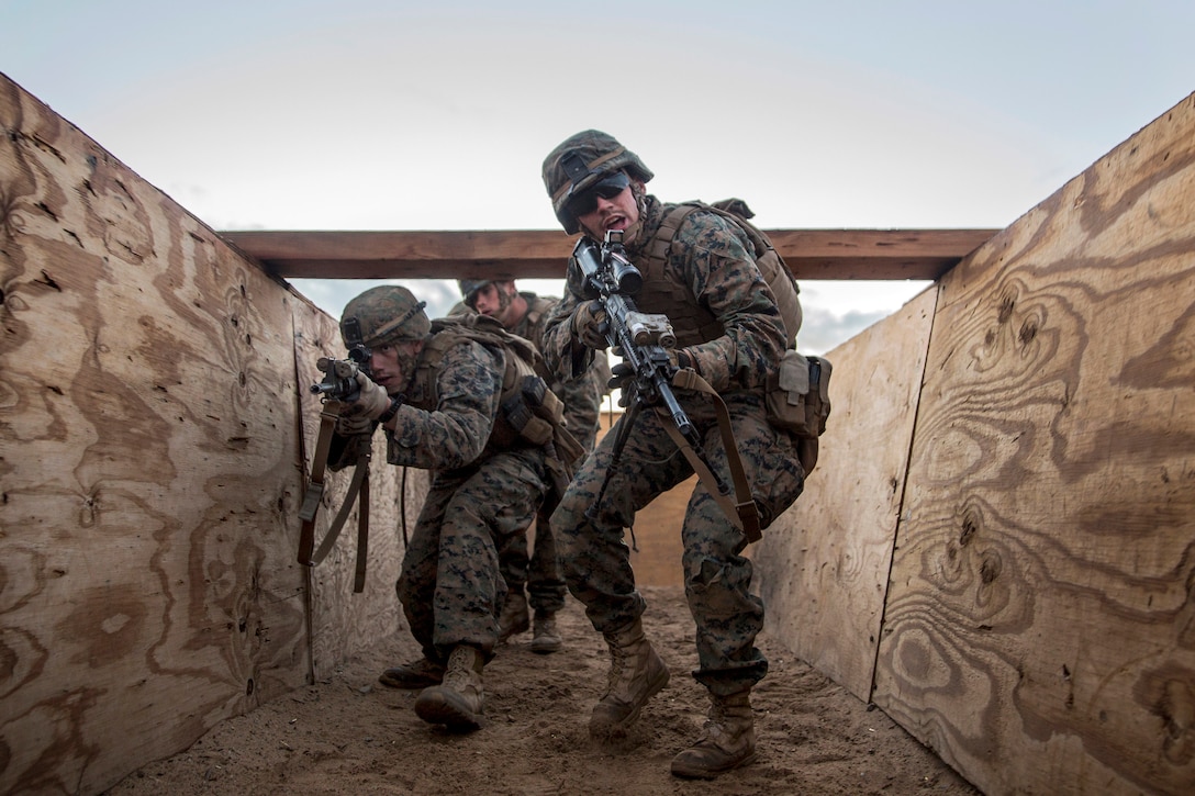 Marines clear a trench during a combined arms exercise on Marine Corps Air Ground Combat Center, Twentynine Palms, Calif., Dec. 12, 2014.