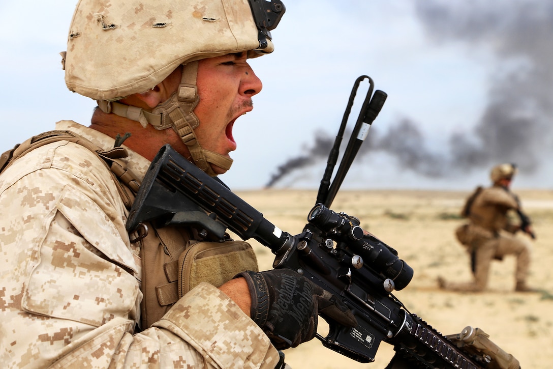 U.S. Marine Corps Cpl. Ty-Michael Maes, left, directs his fire team during a live-fire assault exercise with the Saudi Marines as part of Red Reef 15 in Ras Al Khair, Saudi Arabia, Dec. 16, 2014. Maes is a team leader assigned to 1st Light Armored Reconnaissance detachment, Battalion Landing Team, 2nd Battalion, 1st Marines, 11th Marine Expeditionary Unit.