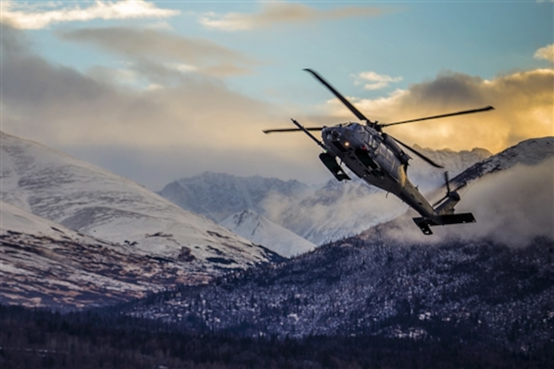 An HH-60 Pave Hawk helicopter practices maneuvers above Bryant Army Airfield on Joint Base Elmendorf-Richardson, Alaska, Dec. 17, 2014. The service member and helicopter are assigned to the Alaska Air National Guard’s 210th Rescue Squadron.  