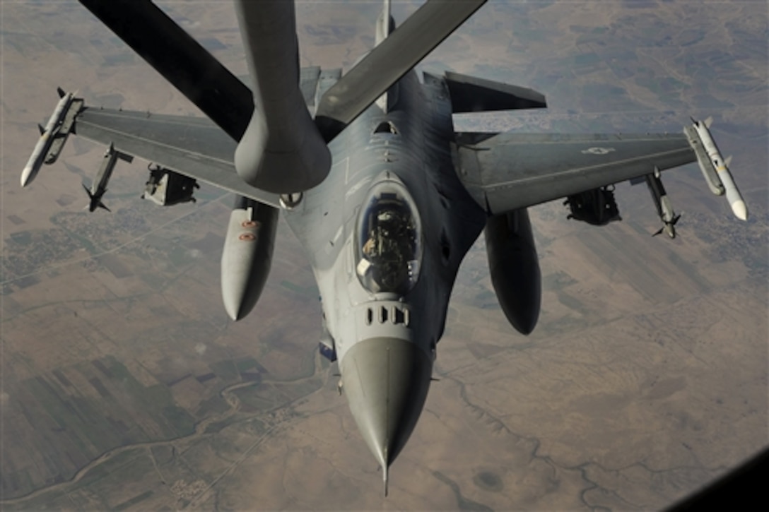 A U.S. Air Force F-16 Fighting Falcon receives fuel from a KC-135 Stratotanker, Dec. 16, 2014, as it supports Operation Inherent Resolve.  