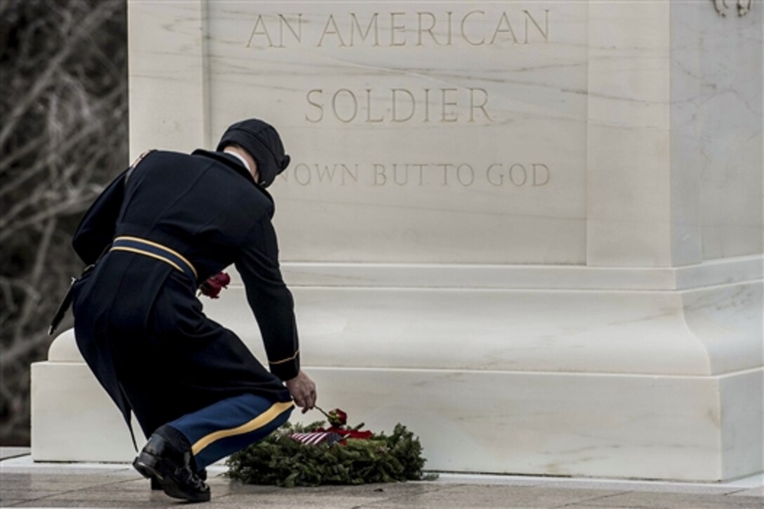 Army Staff Sgt. Robbie Petry places a rose at each of the four crypts at the Tomb of the Unknowns during his last walk ceremony at Arlington National Cemetery in Arlington, Va., Dec. 19, 2014. Petry is tomb sentinel assigned to the Army Honor Guard, 3rd U.S. Infantry Regiment. 
 