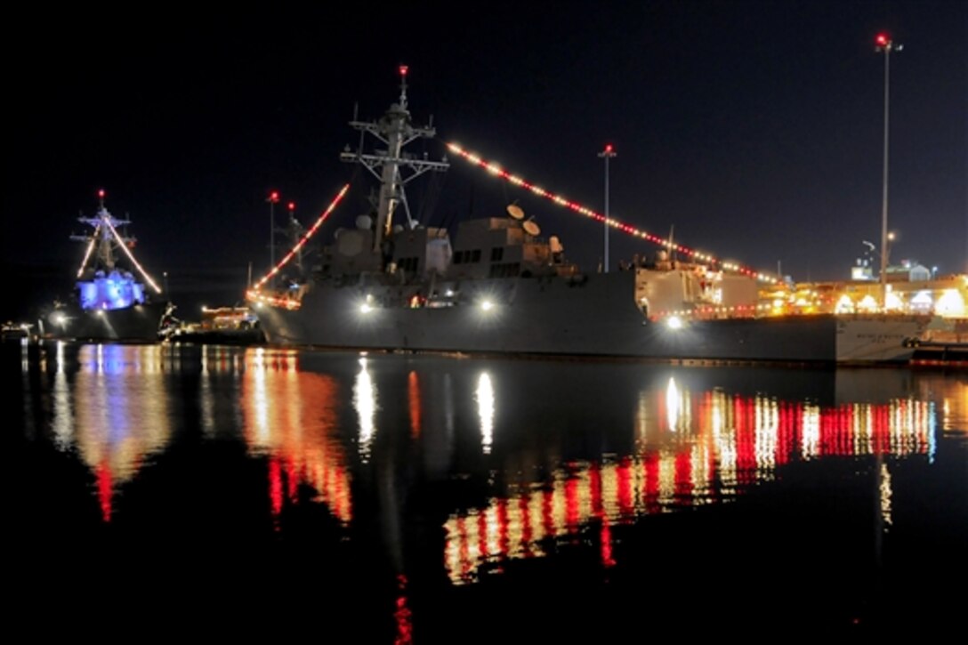 The guided-missile destroyers USS Kidd, left, and USS Wayne E. Meyer display their lights during Naval Base San Diego’s third annual Holiday Lights Open House in San Diego, Dec. 19, 2014. During the event, the public was invited to drive through and observe the decorated ships along the base's waterfront.