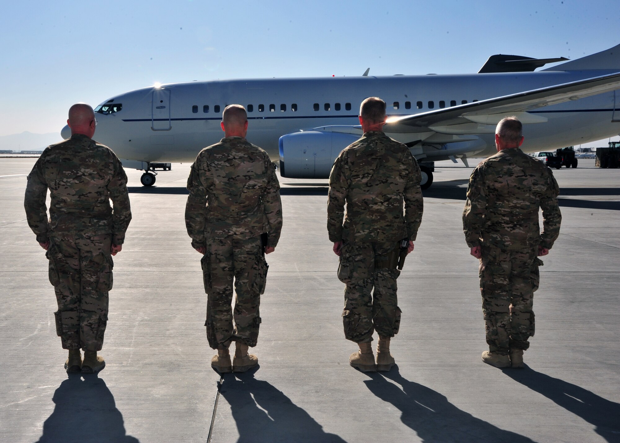 U.S. Air Force Chief Master Sgt. Jeffrey Brown, 455th Air Expeditionary Wing command chief, U.S. Air Force Col. Nathan Allerheiligen, 455 AEW vice commander, U.S. Air Force Brig. Gen. Mark Kelly, 455 AEW commander, and U.S. Air Force Maj. Gen. John McMullen, 9th Air and Space Expeditionary Task Force Afghanistan commander, stand at attention as a plane carrying Air Force Chief of Staff Gen. Mark A. Welsh III and his wife, Betty, taxis into position Dec. 15, 2014 at Bagram Airfield, Afghanistan. During the visit, Welsh spoke with Airmen, listened to their stories of service, updated them on pressing issues facing the Air Force, and thanked them for their service. (U.S. Air Force photo by Staff Sgt. Whitney Amstutz/released)