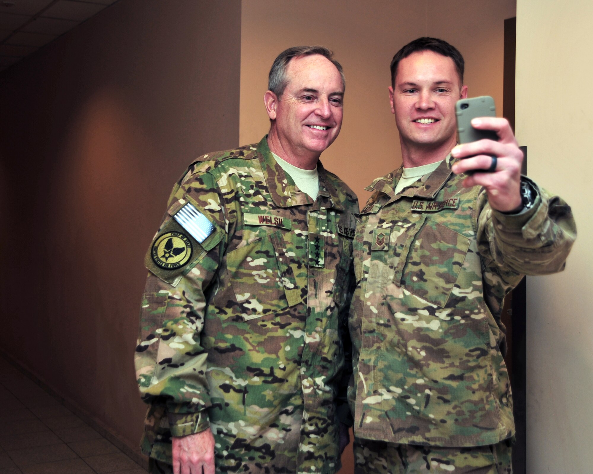 U.S. Air Force Chief of Staff Gen. Mark A. Welsh III takes a photo with U.S. Air Force Master Sgt. Luke Carter, 817th Expeditionary Air Support Operations Squadron Tactical Air Control Party superintendent, after he recognized the Airman Dec. 15, 2014 at Bagram Airfield, Afghanistan. In addition to awarding excellence, Welsh spoke with Airmen during an all-call, listened to their stories of service, updated them on pressing issues facing the Air Force, and thanked them for their service. (U.S. Air Force photo by Staff Sgt. Whitney Amstutz/released)