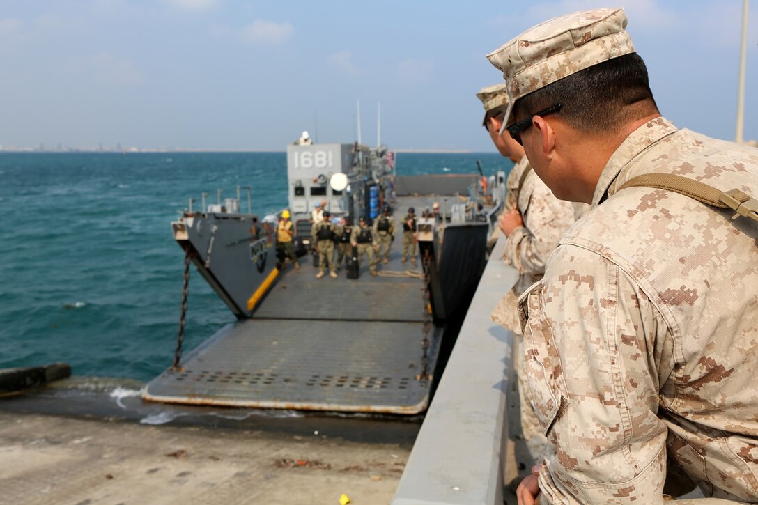 Capt. Larry Iverson Jr., commanding officer of Echo Company, Battalion Landing Team 2nd Battalion, 1st Marines, 11th Marine Expeditionary Unit (MEU), watches a landing craft utilitycome ashore to retrieve Marines and Sailors with the 11th MEU before returning to the dock landing ship USS Comstock (LSD 45) following exercise Red Reef 15 in Ras Al Ghar, Saudi Arabia. Red Reef is part of a routine theater security cooperation engagement plan between the U.S. Navy, U.S. Marine Corps and Royal Saudi Naval Forces that serves as an excellent opportunity to strengthen tactical proficiency in critical mission areas and support long-term regional security. (U.S. Marine Corps photo by Sgt. Melissa Wenger/Released)